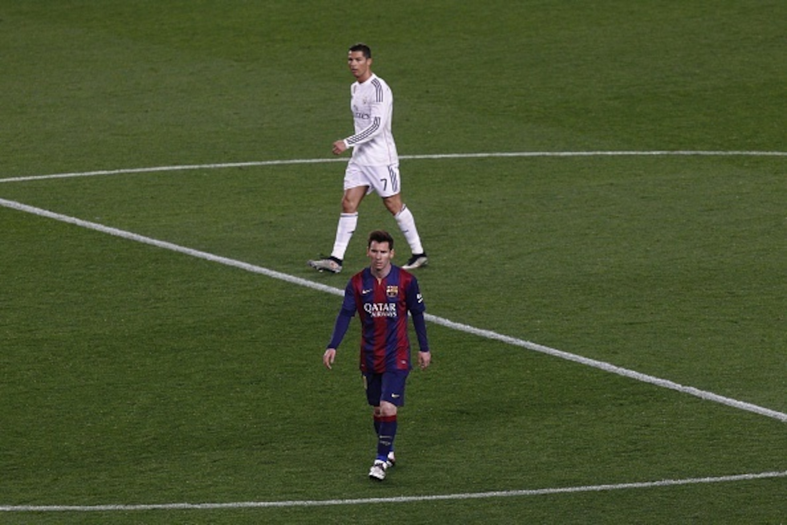 Barcelona's Argentinian forward Lionel Messi (DOWN)  and Real Madrid's Portuguese forward Cristiano Ronaldo walk on the field during the 'clasico' Spanish league football match FC Barcelona vs Real Madrid CF at the Camp Nou stadium in Barcelona on March 2