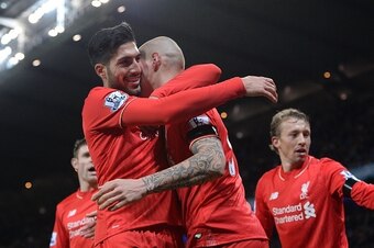 Liverpool's German midfielder Emre Can (L) congratulates Liverpool's Slovakian defender Martin Skrtel after he scored his team's fourth goal during the English Premier League football match between Manchester City and Liverpool at The Etihad stadium in Ma