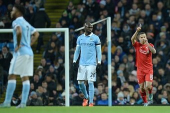 Manchester City's French defender Eliaquim Mangala (C) looks on as Liverpool's Brazilian midfielder Philippe Coutinho (R) celebrates after scoring their second goal during the English Premier League football match between Manchester City and Liverpool at 