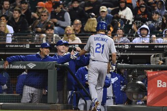 SAN FRANCISCO, CA - SEPTEMBER 13:  Zack Greinke #21 of the Los Angeles Dodgers is congratulated by manager Don Mattingly #8 after Geinke hit a two-run homer against the San Francisco Giants in the top of the six inning at AT&T Park on September 13, 2014 i