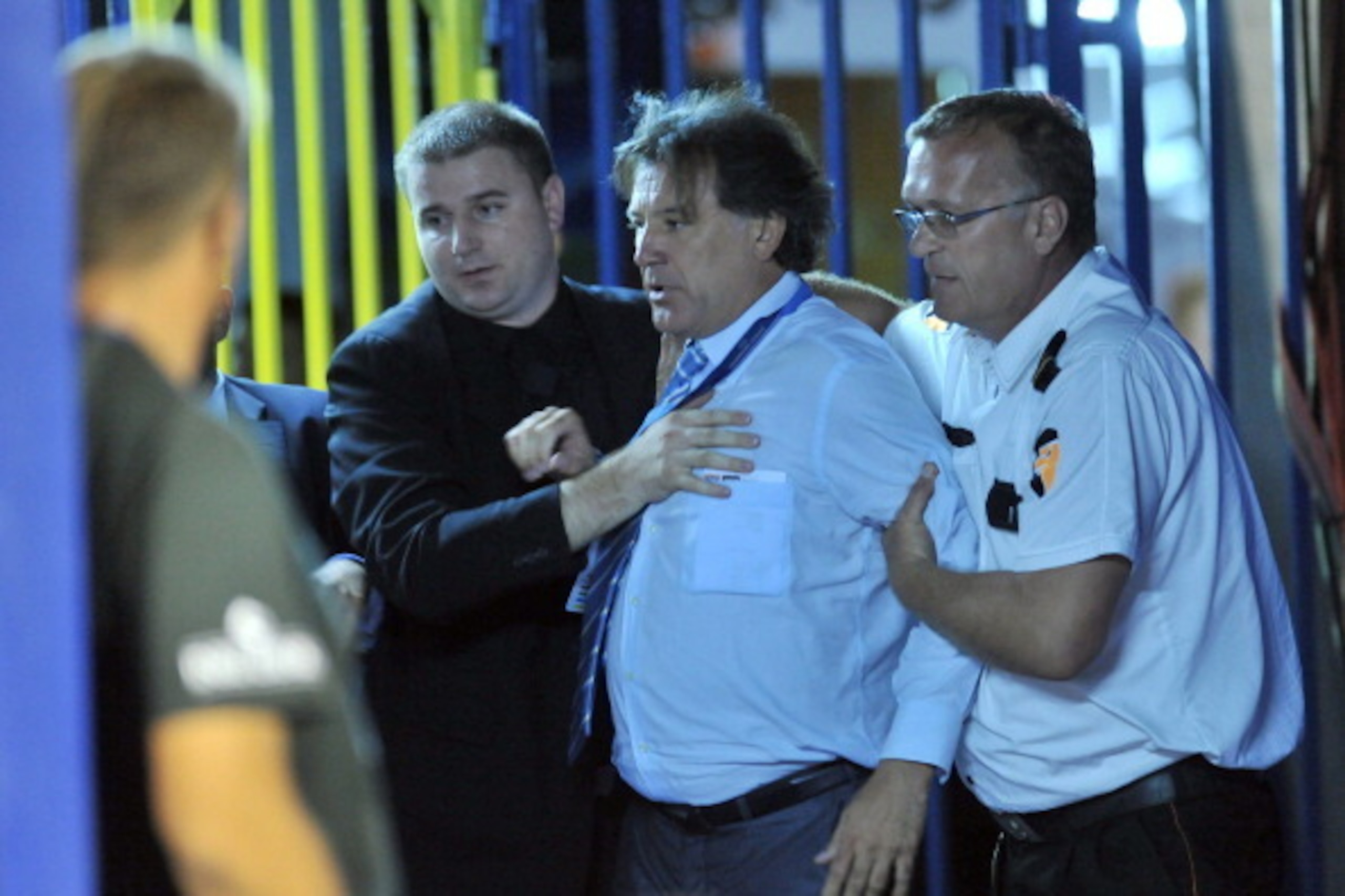 NK Dinamo Zagreb's executive Zdravko Mamic (C) is held back  by private security agents facing a police officer (not in pic) late August 17, 2011 in Zagreb following his team match vs Malmo. Mamic  was detained overnight after a brawl with police followin