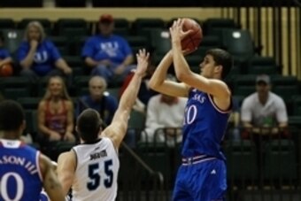 Nov 27, 2014; Kissimmee, FL, USA; Kansas Jayhawks guard Sviatoslav Mykhailiuk (10) shoots over Rhode Island Rams forward Gilvydas Biruta (55)  during the first half at HP Field house at Wide World of Sports Complex. Mandatory Credit: Kim Klement-USA TODAY