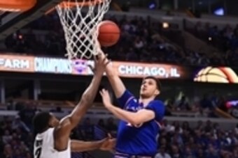 Nov 17, 2015; Chicago, IL, USA; Kansas Jayhawks guard Sviatoslav Mykhailiuk (10) shoots the ball against Michigan State Spartans forward Javon Bess (2) during the first half at the United Center. Mandatory Credit: Mike DiNovo-USA TODAY Sports
