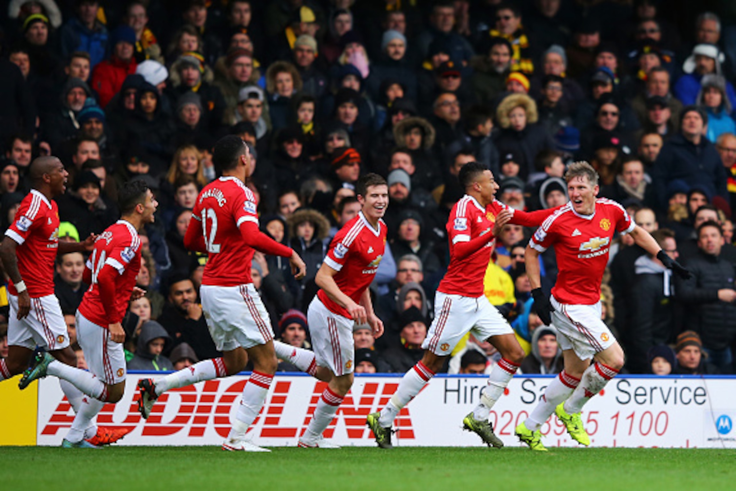 WATFORD, ENGLAND - NOVEMBER 21:  Bastian Schweinsteiger (1st R) of Manchester United celebrates his team's second goal scored by Troy Deeney of Watford with his team mates during the Barclays Premier League match between Watford and Manchester United at V