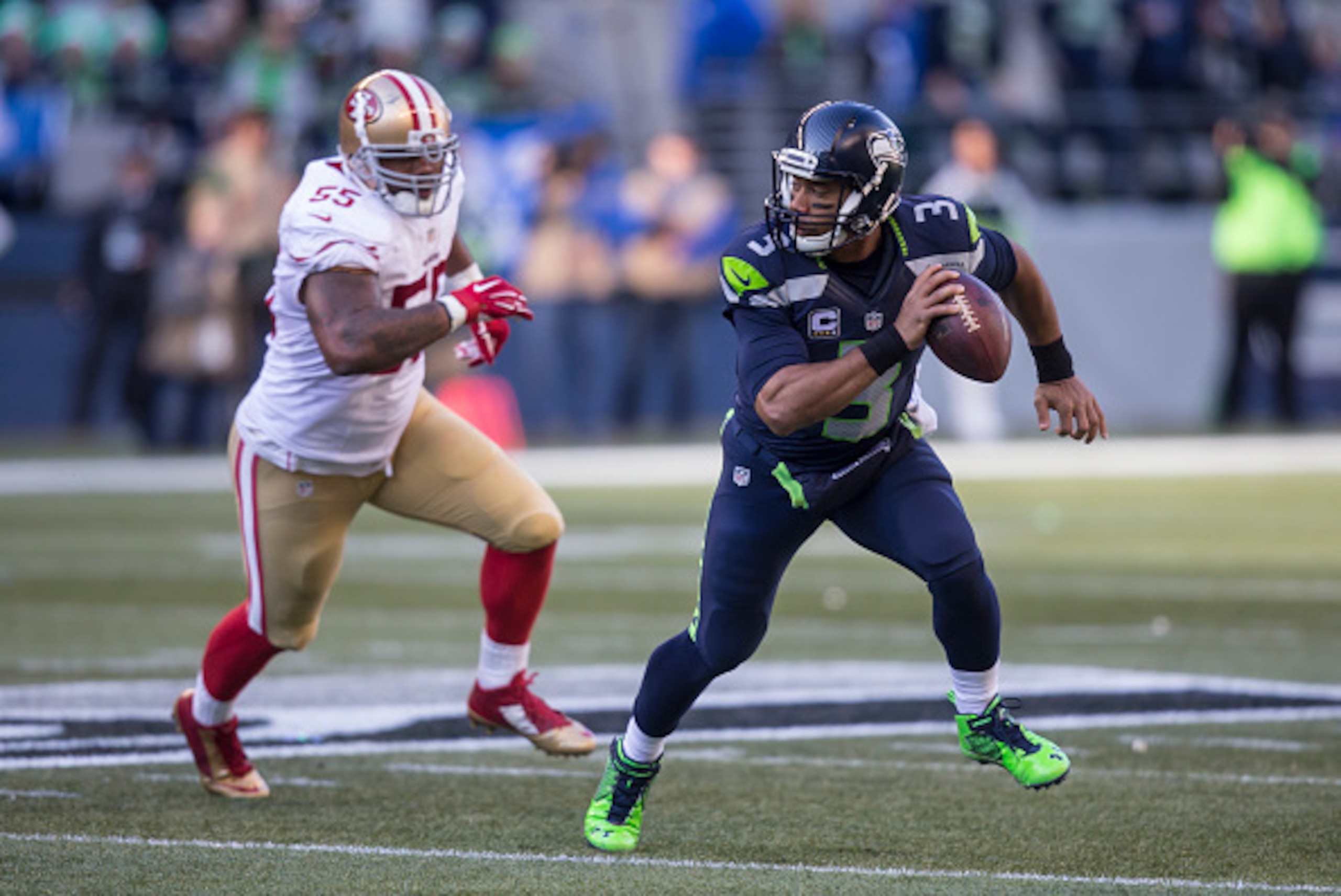 SEATTLE, WA - NOVEMBER 22: Quarterback Russell Wilson #3 of the Seattle Seahawks scrambles out of the pocket as he is chased by linebacker Ahmad Brooks #55 of the San Francisco 49ers during the first half of a game at CenturyLink Field on November 22, 201 SEATTLE, WA - NOVEMBER 22: Quarterback Russell Wilson #3 of the Seattle Seahawks scrambles out of the pocket as he is chased by linebacker Ahmad Brooks #55 of the San Francisco 49ers during the first half of a game at CenturyLink Field on November 22, 201