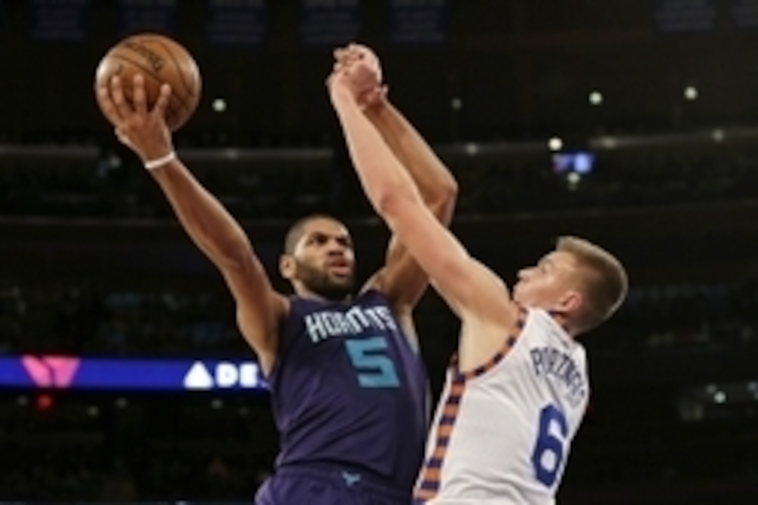 Nov 17, 2015; New York, NY, USA; Charlotte Hornets guard Nicolas Batum (5) shoots the ball over New York Knicks forward Kristaps Porzingis (6) during the first half at Madison Square Garden. Mandatory Credit: Adam Hunger-USA TODAY Sports
