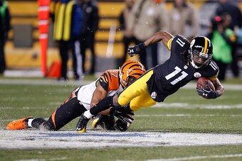 PITTSBURGH, PA - DECEMBER 28:  Markus Wheaton #11 of the Pittsburgh Steelers gets tripped up by Vincent Rey #57 of the Cincinnati Bengals during the second quarter at Heinz Field on December 28, 2014 in Pittsburgh, Pennsylvania.  (Photo by Gregory Shamus/