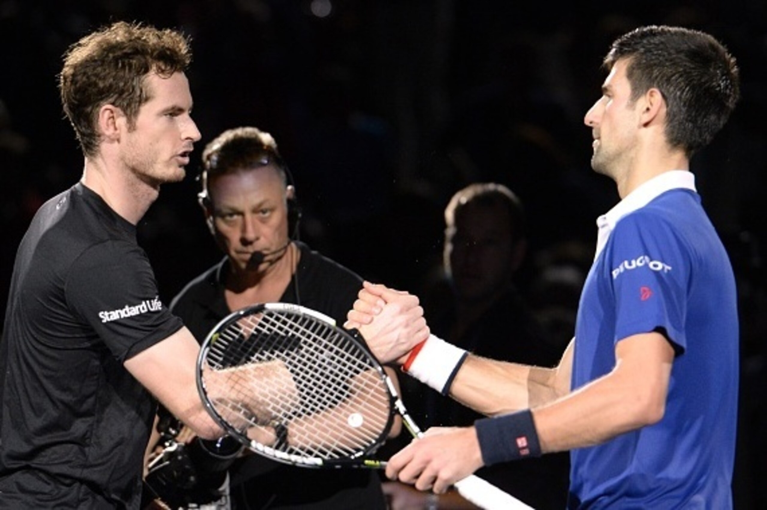 Serbia's Novak Djokovic (R) shakes hands with Britain's Andy Murray after winning the final tennis match at the ATP World Tour Masters 1000 indoor tennis tournament in Paris on November 8, 2015. AFP PHOTO / MIGUEL MEDINA        (Photo credit should read M