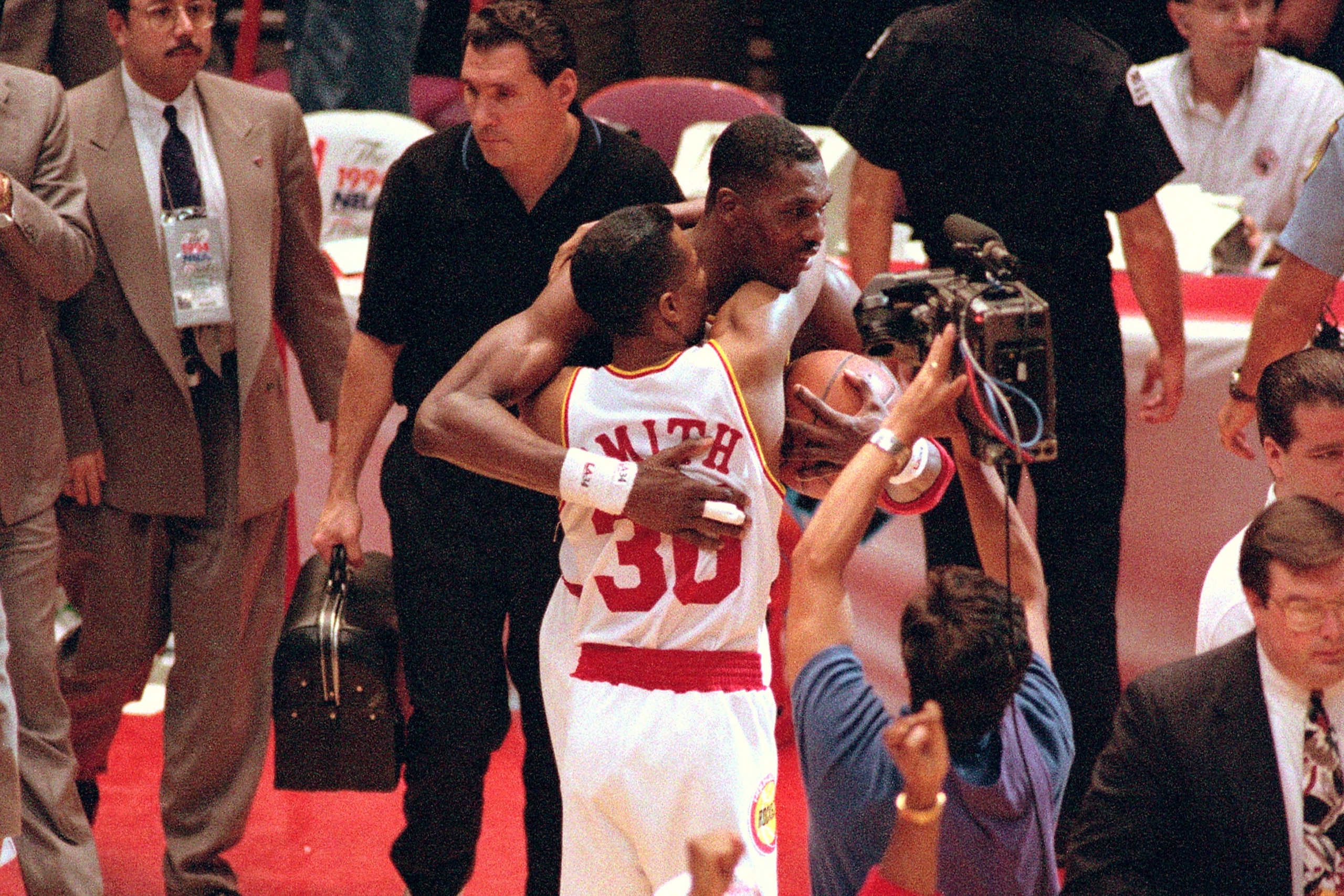 HOUSTON, TX - JUNE 22:  Kenny Smith #30 and Hakeem Olajuwon #34 of the Houston Rockets celebrate after beating the New York Knicks in Game Seven of the NBA Finals on June 22, 1994 at The Summit in Houston, Texas. NOTE TO USER: User expressly acknowledges