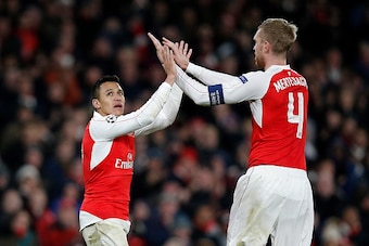 Arsenal's Chilean striker Alexis Sanchez (L) celebrates after scoring his team's third goal during their UEFA Champions League Group F football match between Arsenal and GNK Dinamo Zagreb at The Emirates Stadium in London on November 24, 2015.  AFP PHOTO 