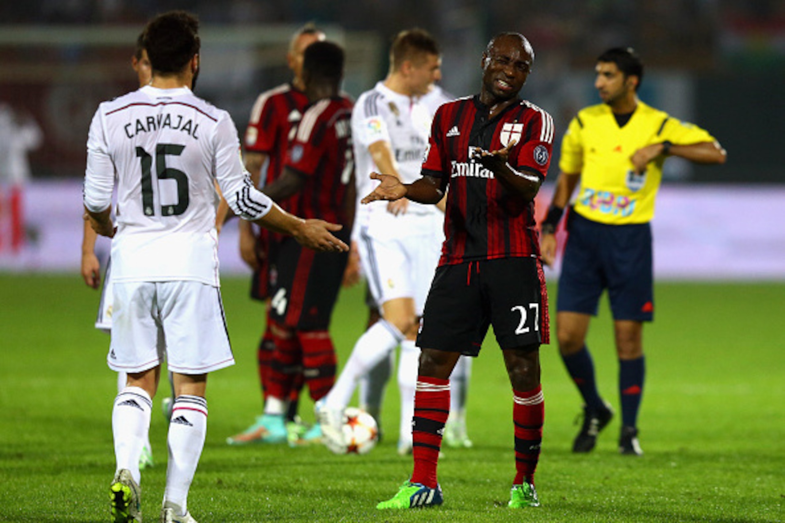 DUBAI, UNITED ARAB EMIRATES - DECEMBER 30:  Pablo Estifer Armero of AC Milan exchanges words with Carvajal of Real Madrid during the Dubai Football Challenge match between AC Milan and Real Madrid at The Sevens Stadium  on December 30, 2014 in Dubai, Unit