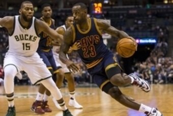 Nov 14, 2015; Milwaukee, WI, USA; Cleveland Cavaliers forward LeBron James (23) dribbles the ball around Milwaukee Bucks center Greg Monroe (15) during the second quarter at BMO Harris Bradley Center. Mandatory Credit: Jeff Hanisch-USA TODAY Sports