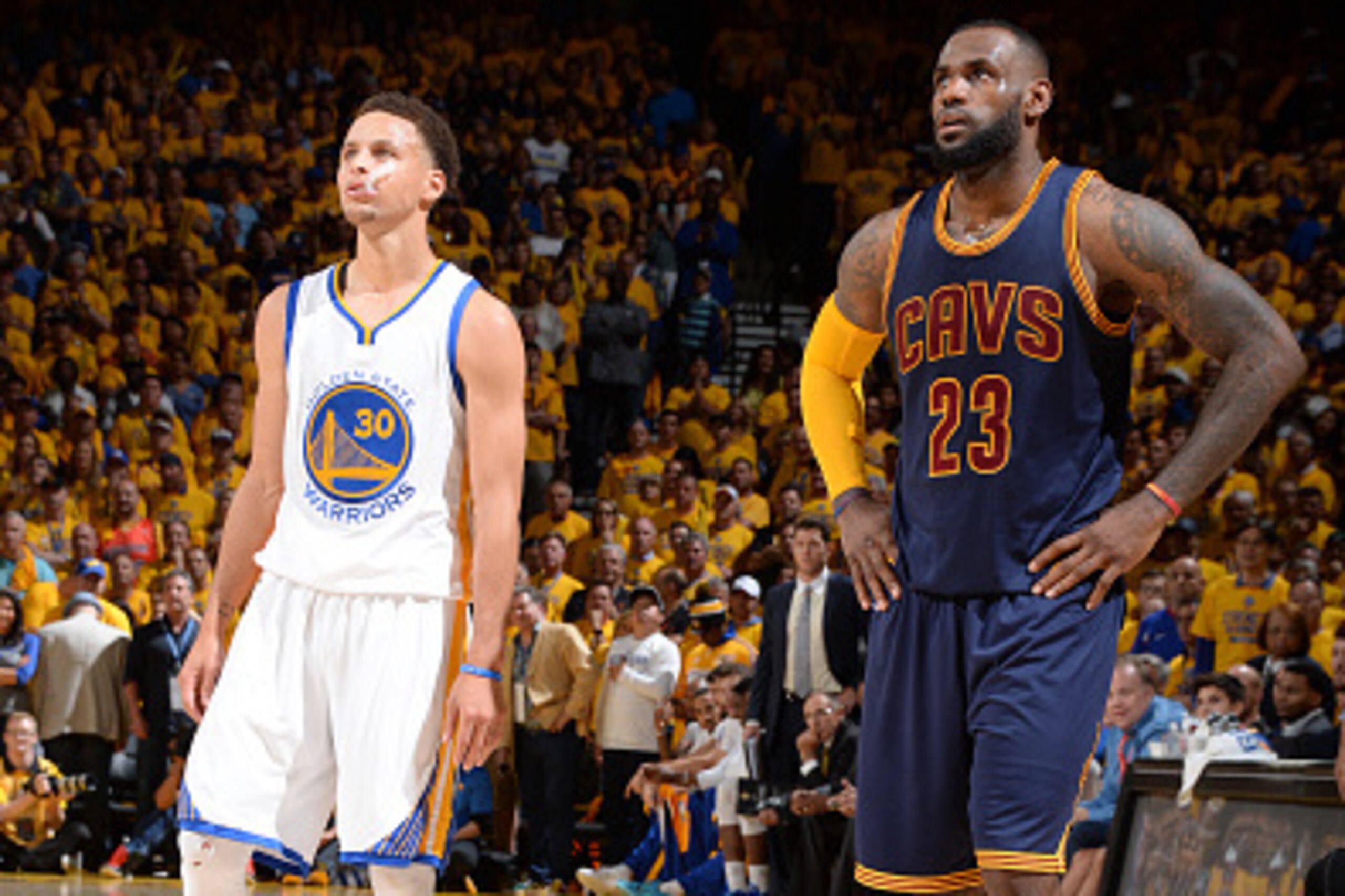 OAKLAND, CA - JUNE 14: Stephen Curry #30 of the Golden State Warriors and LeBron James #23 of the Cleveland Cavaliers stand on the court during Game Five of the 2015 NBA Finals at Oracle Arena on June 14, 2015 in Oakland, California. NOTE TO USER: User ex