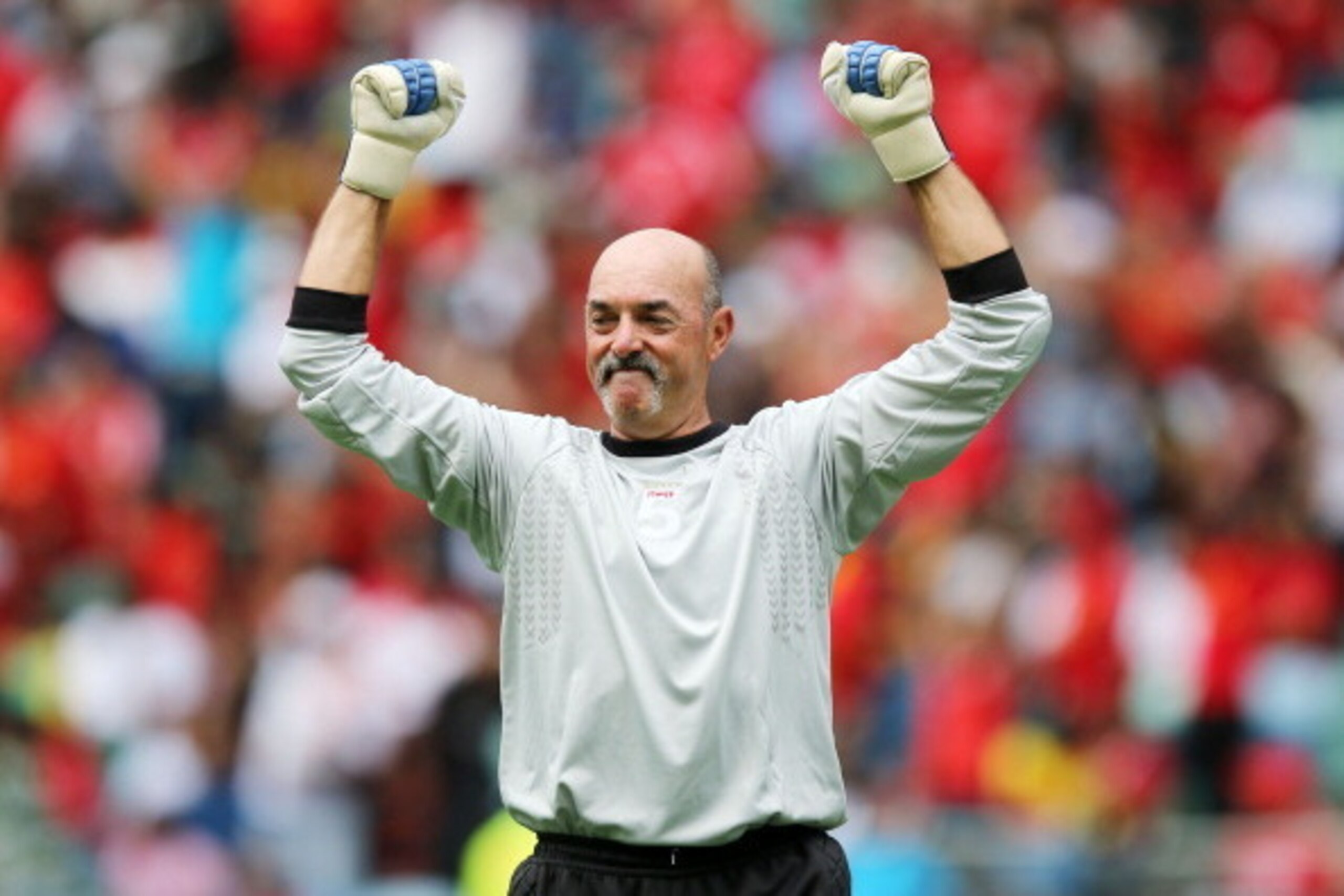 DURBAN, SOUTH AFRICA - NOVEMBER 16: In this handout image provided by the ITM Group,  Bruce Grobbelaar celebrates during the Legends match between Liverpool FC Legends and Kaizer Chiefs Legends at Moses Mabhida Stadium on November 16, 2013 in Durban, Sout