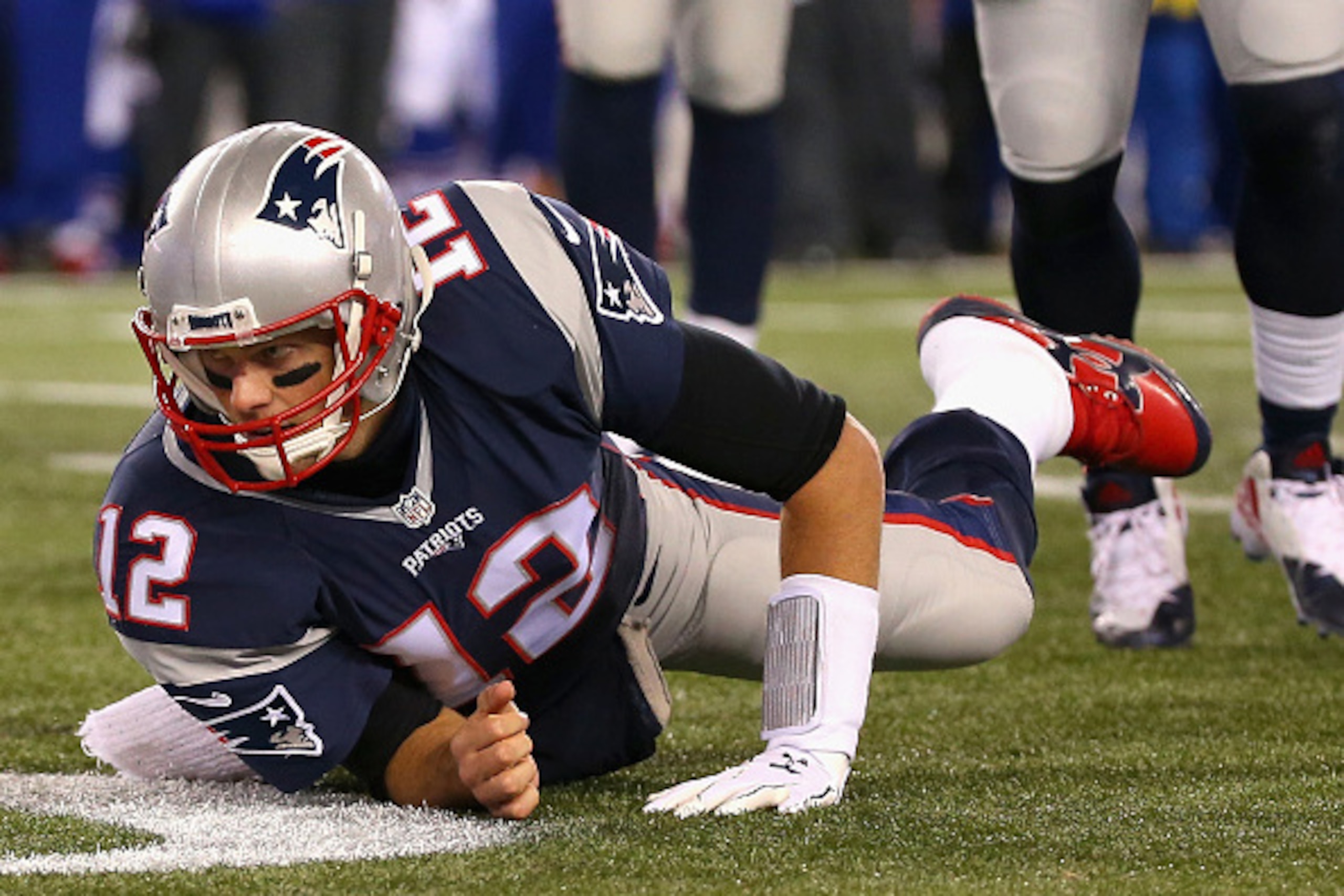 FOXBORO, MA - NOVEMBER 23:  Tom Brady #12 of the New England Patriots is tackled during the second quarter against the Buffalo Bills at Gillette Stadium on November 23, 2015 in Foxboro, Massachusetts.  (Photo by Jim Rogash/Getty Images)