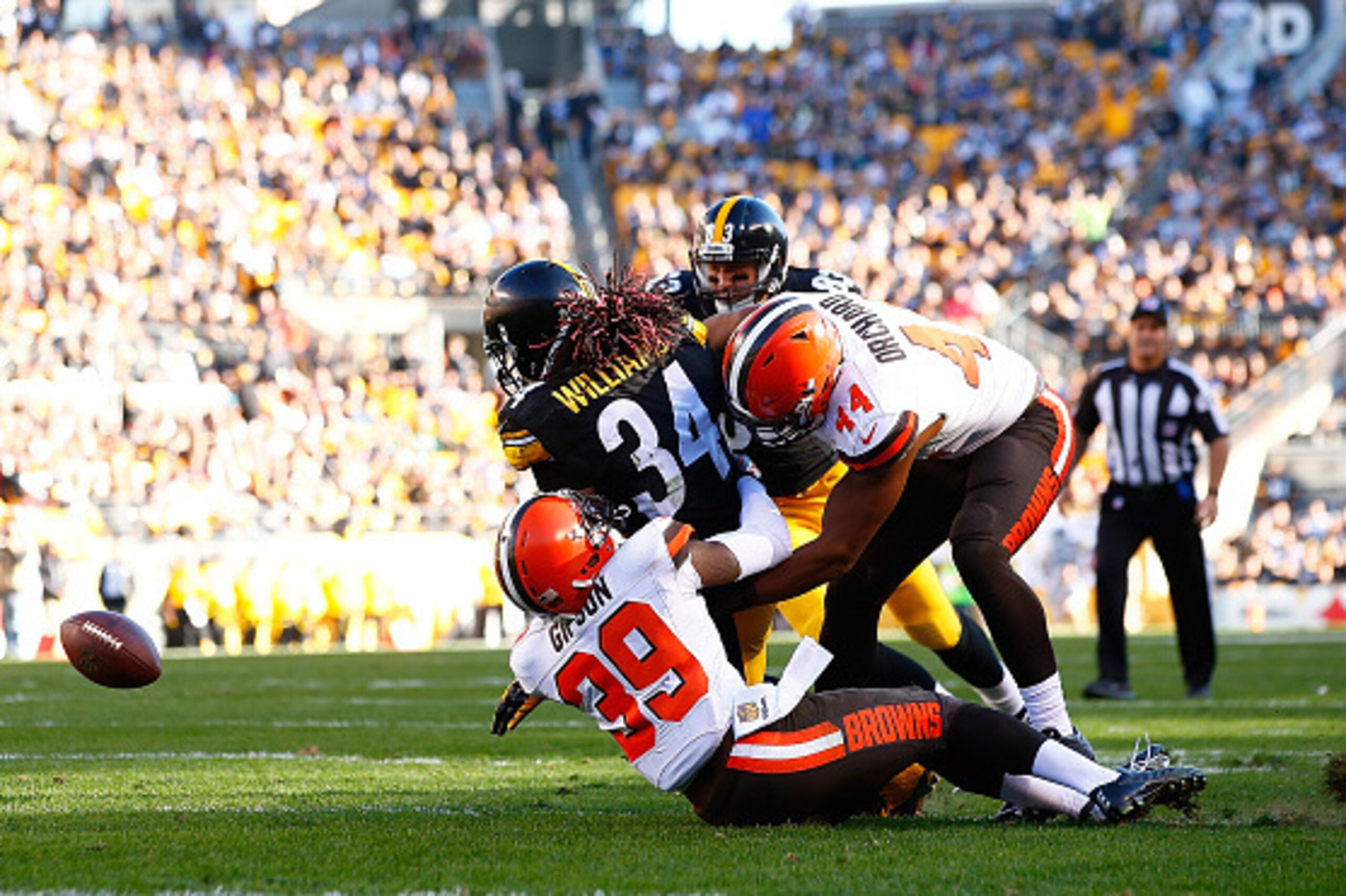 PITTSBURGH, PA - NOVEMBER 15:  DeAngelo Williams #34 of the Pittsburgh Steelers fumbles the ball after being hit by Tashaun Gipson #39 and Nate Orchard #44 of the Cleveland Browns during the 2nd quarter of the game at Heinz Field on November 15, 2015 in P