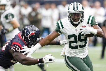 HOUSTON, TX - NOVEMBER 22: Bilal Powell #29 of the New York Jets rushes past Whitney Mercilus #59 of the Houston Texans in the third quarter on November 22, 2015 at NRG Stadium in Houston, Texas. Texans won 24 to 17. (Photo by Thomas Shea/Getty Images)