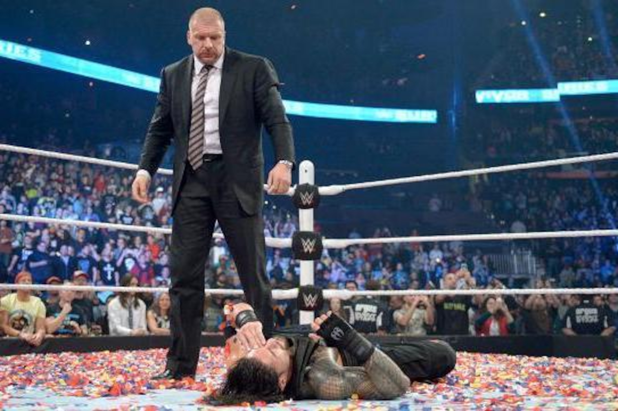 Triple H stands over a fallen Roman Reigns at Survivor Series. Triple H stands over a fallen Roman Reigns at Survivor Series.