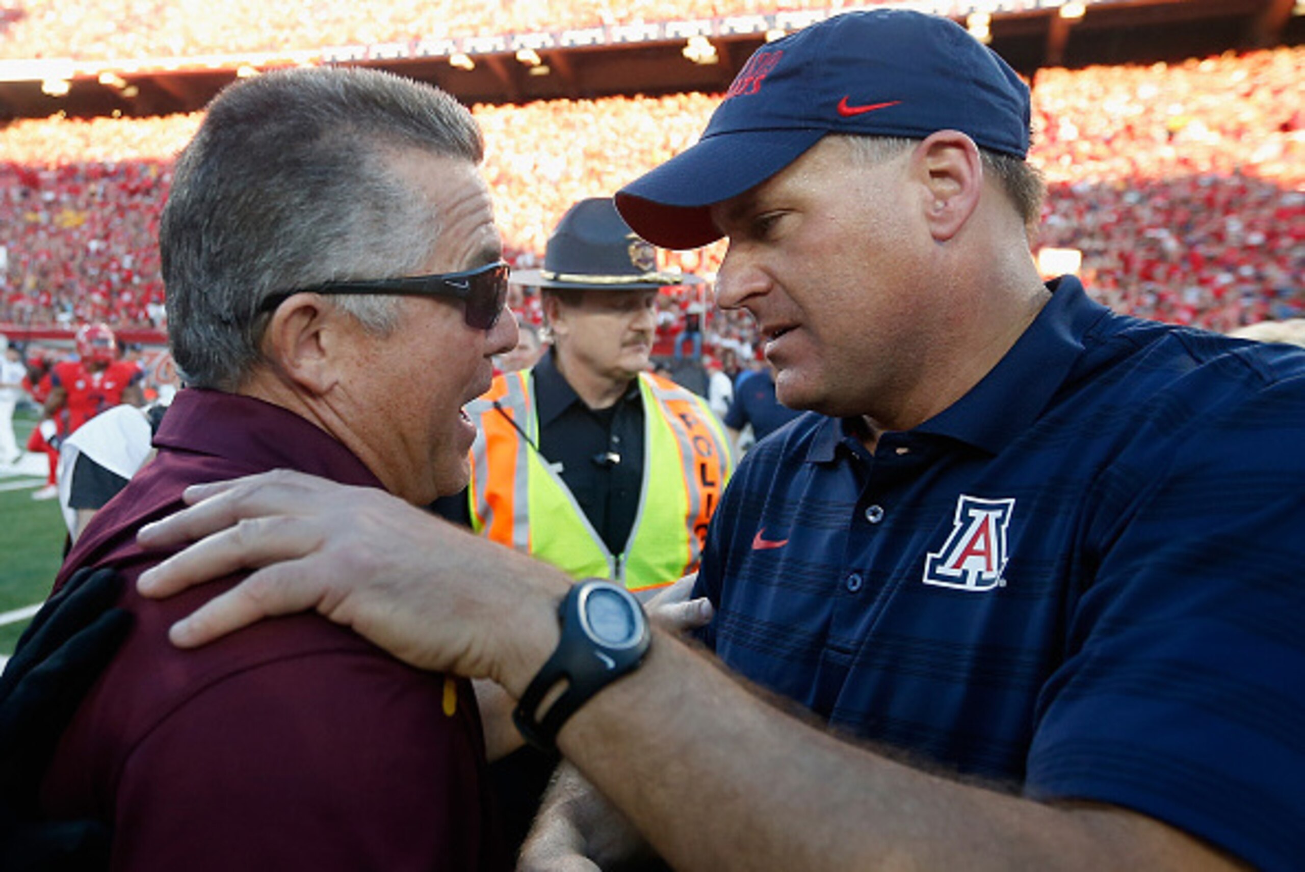 TUCSON, AZ - NOVEMBER 28:  Head coaches Rich Rodriguez (R) of the Arizona Wildcats and Todd Graham of the Arizona State Sun Devils shake hands after the Wildcats defeated the Sun Devils 42-35 to win PAC-12 south championship following the Territorial Cup