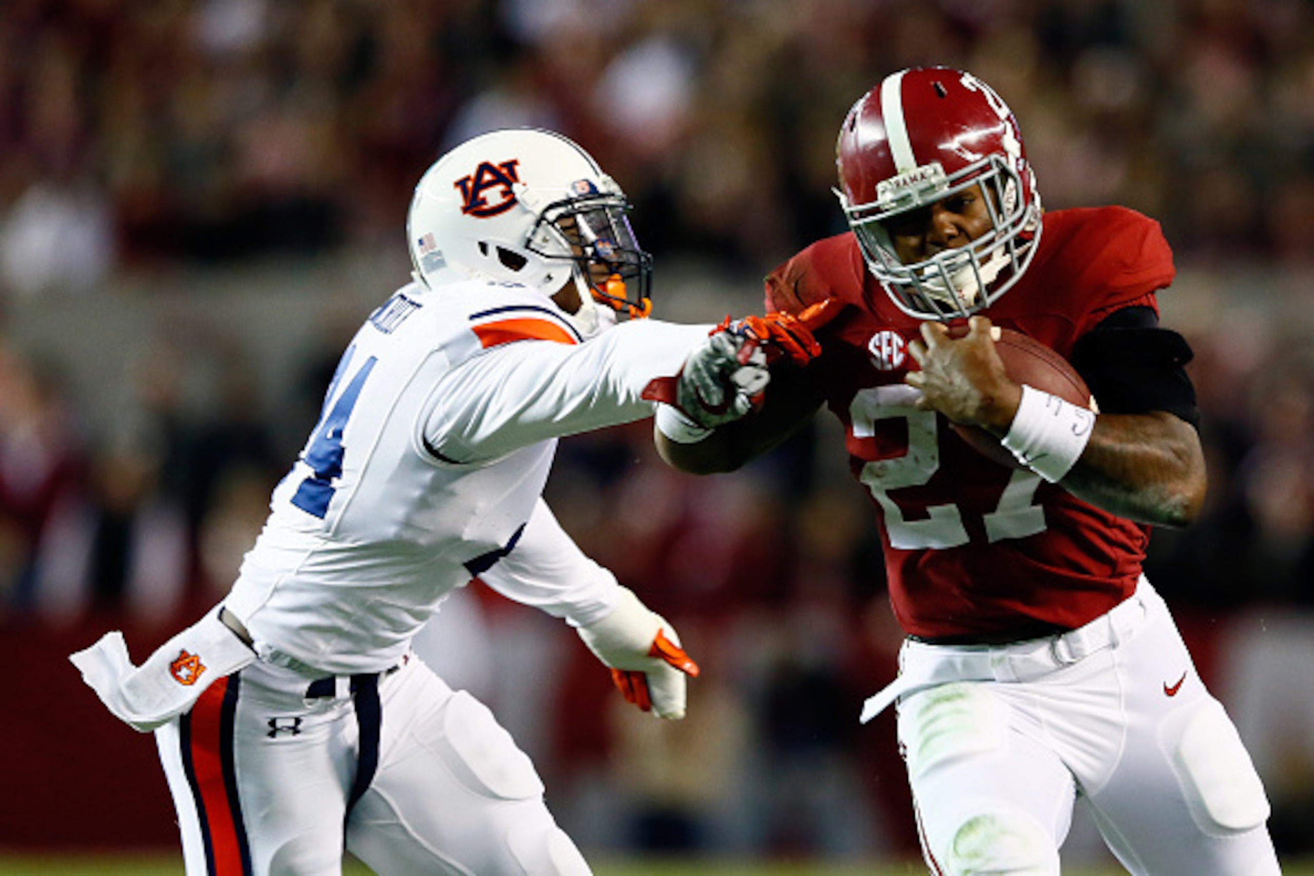 TUSCALOOSA, AL - NOVEMBER 29:  Derrick Henry #27 of the Alabama Crimson Tide runs the ball in the fourth quarter against the Auburn Tigers during the Iron Bowl at Bryant-Denny Stadium on November 29, 2014 in Tuscaloosa, Alabama.  (Photo by Kevin C. Cox/Ge