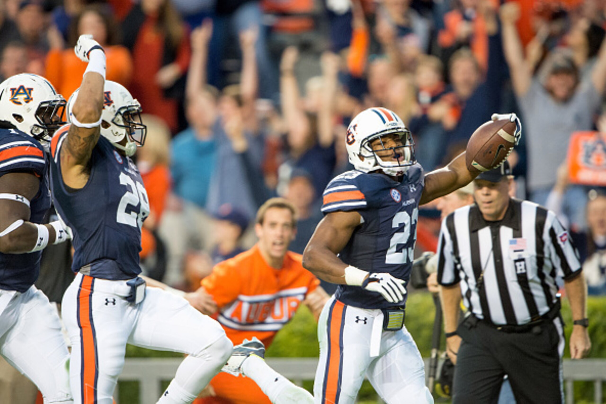 AUBURN, AL - NOVEMBER 21: Defensive back Johnathan Ford #23 celebrates with defensive back Tray Matthews #28 and defensive tackle Montravius Adams #1 of the Auburn Tigers after scoring a touchdown off an interception during their game against the Idaho Va
