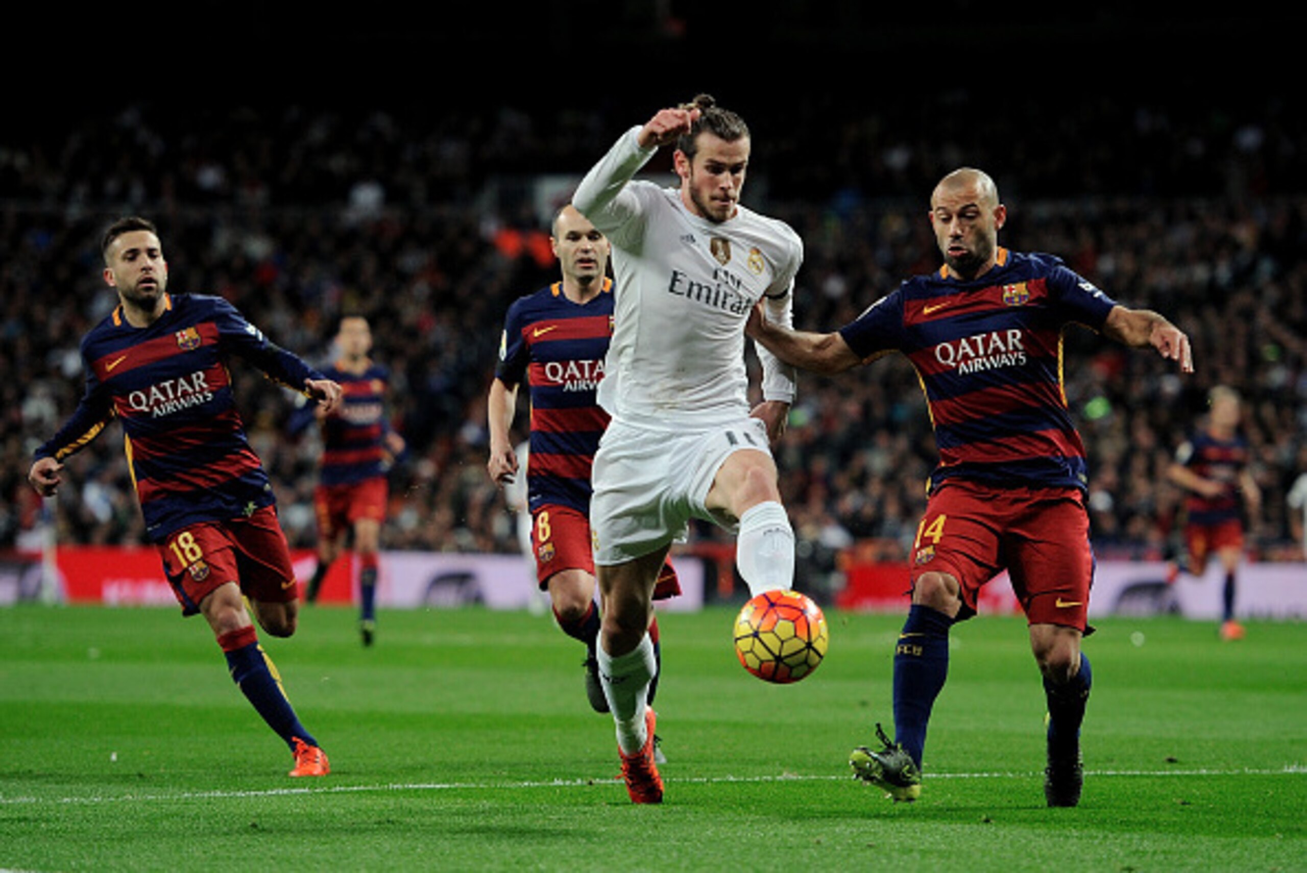 MADRID, SPAIN - NOVEMBER 21:  Gareth Bale of Real Madrid is tackled by Javier Mascherano of FC Barcelona during the La Liga match between Real Madrid and Barcelona at Estadio Santiago Bernabeu on November 21, 2015 in Madrid, Spain.  (Photo by Denis Doyle/