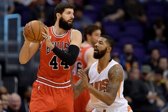 Nov 18, 2015; Phoenix, AZ, USA; Chicago Bulls forward Nikola Mirotic (44) handles the basketball against Phoenix Suns forward Markieff Morris (11) in the first half of the NBA game at Talking Stick Resort Arena. Mandatory Credit: Jennifer Stewart-USA TODA