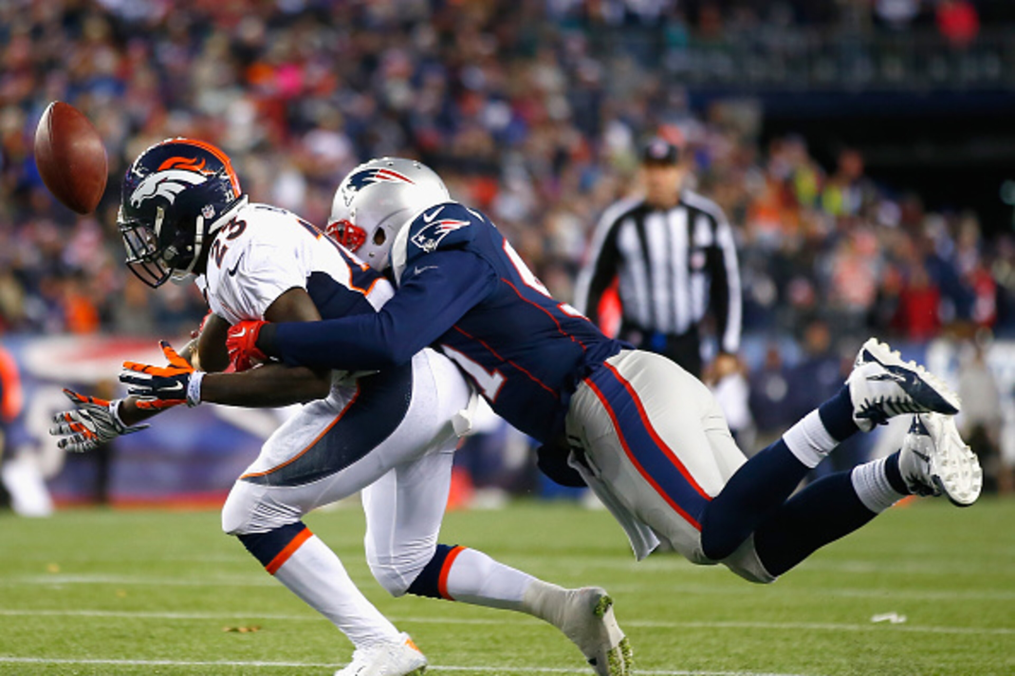 FOXBORO, MA - NOVEMBER 02:  Ronnie Hillman #23 of the Denver Broncos drops a pass as he is tackled by Jamie Collins #91 of the New England Patriots during the first quarter at Gillette Stadium on November 2, 2014 in Foxboro, Massachusetts.  (Photo by Jare
