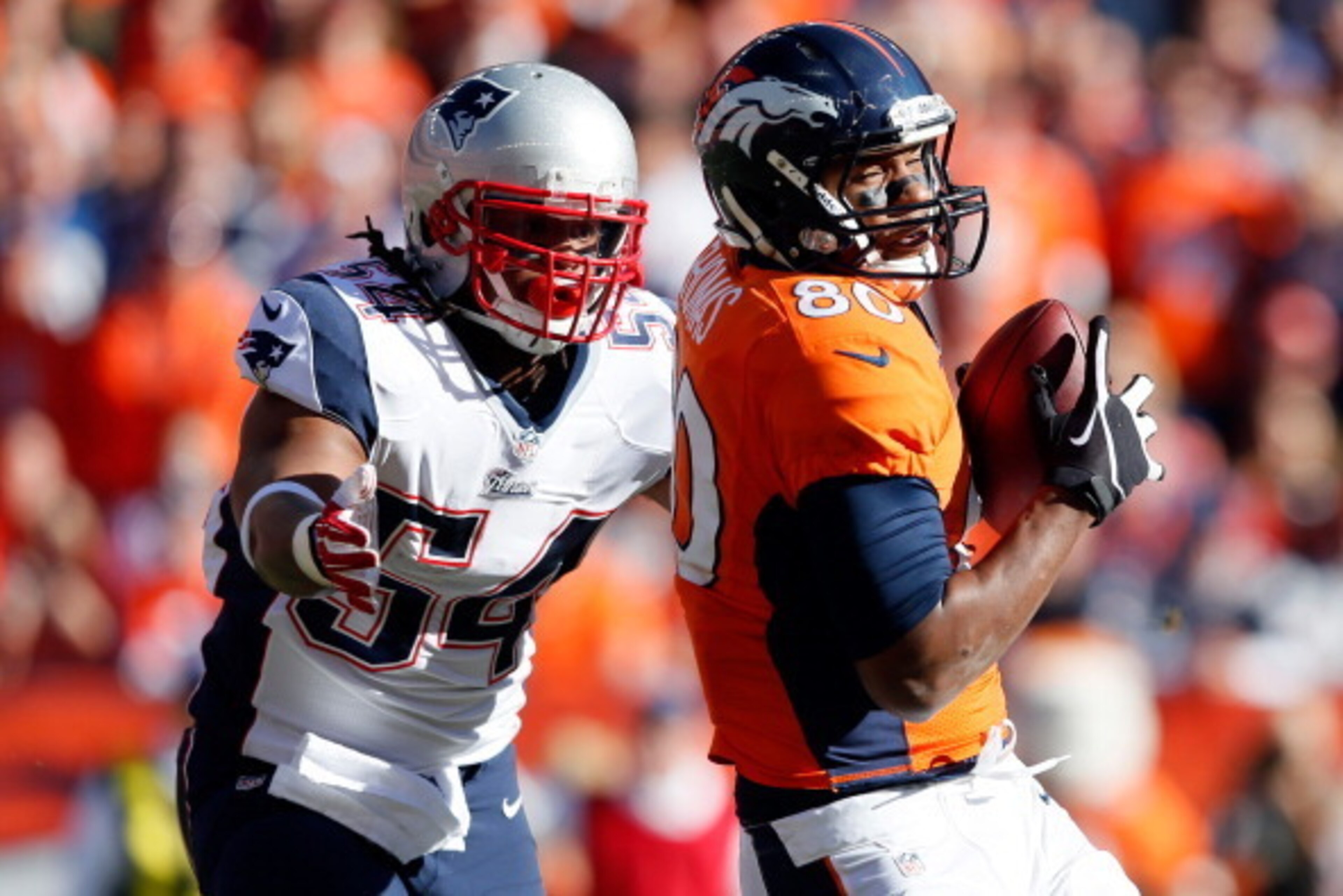 DENVER, CO - JANUARY 19:  Julius Thomas #80 of the Denver Broncos catches a pass against Dont'a Hightower #54 of the New England Patriots during the AFC Championship game at Sports Authority Field at Mile High on January 19, 2014 in Denver, Colorado.  (Ph