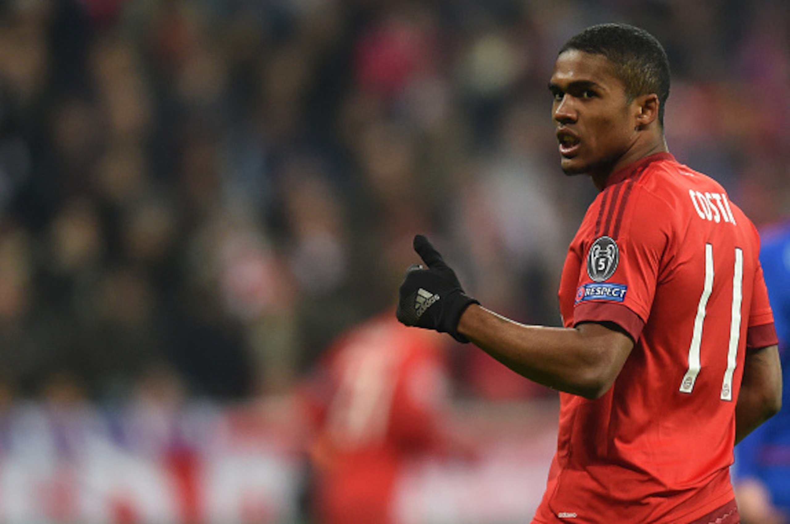 Bayern Munich's Brazilian midfielder Douglas Costa reacts during the UEFA Champions League Group F football match between FCB Bayern Munich and Olympiakos Piraeus on November 24, 2015 at the 'Allianz Arena' in Munich, southern Germany. AFP PHOTO / CHRISTO