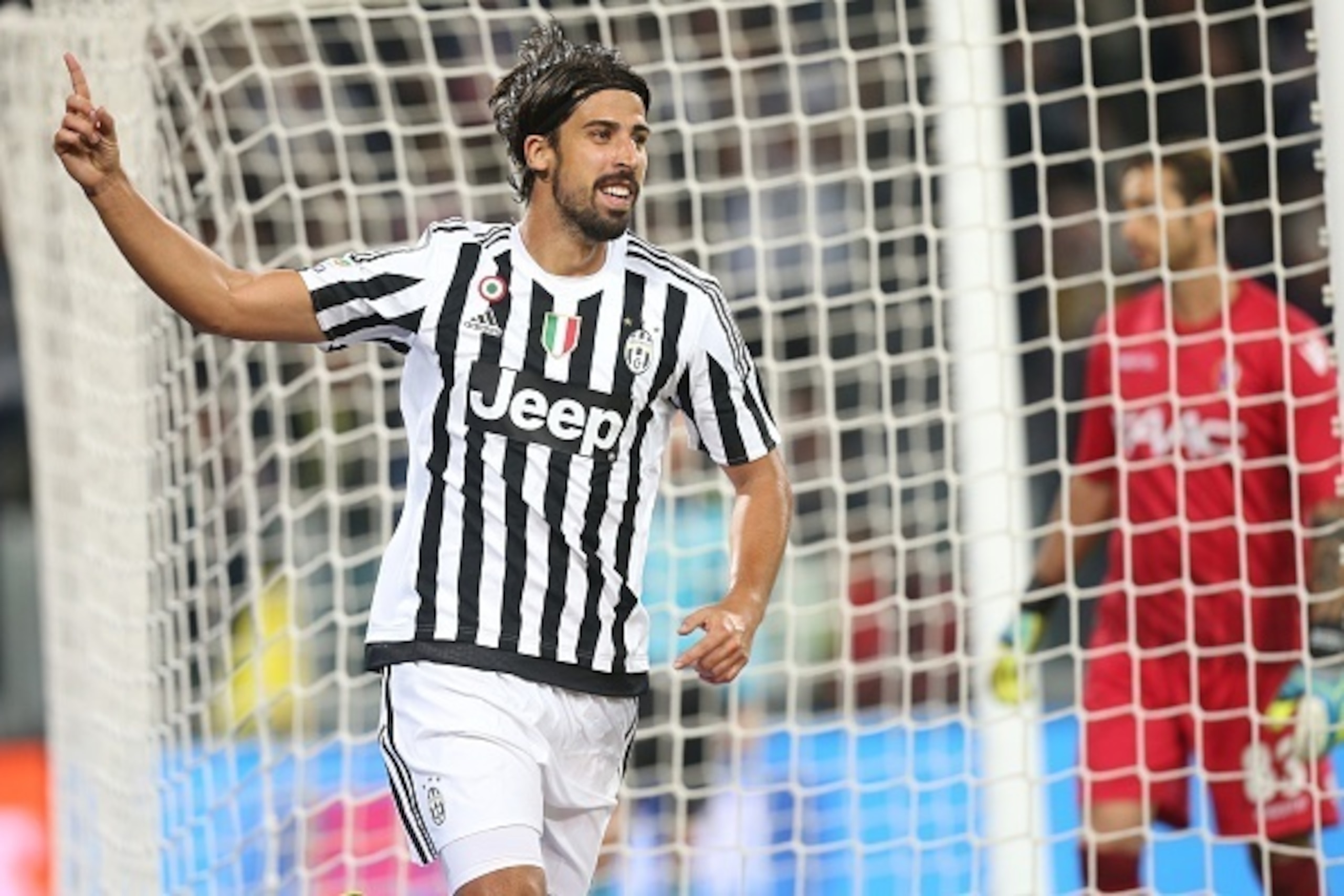 Juventus' midfielder Sami Khedira (L) from Germany celebrates after scoring during the Italian Serie A  football match Juventus Vs Bologna on October 4, 2015 at the 'Juventus Stadium' in Turin.  AFP PHOTO / MARCO BERTORELLO        (Photo credit should rea