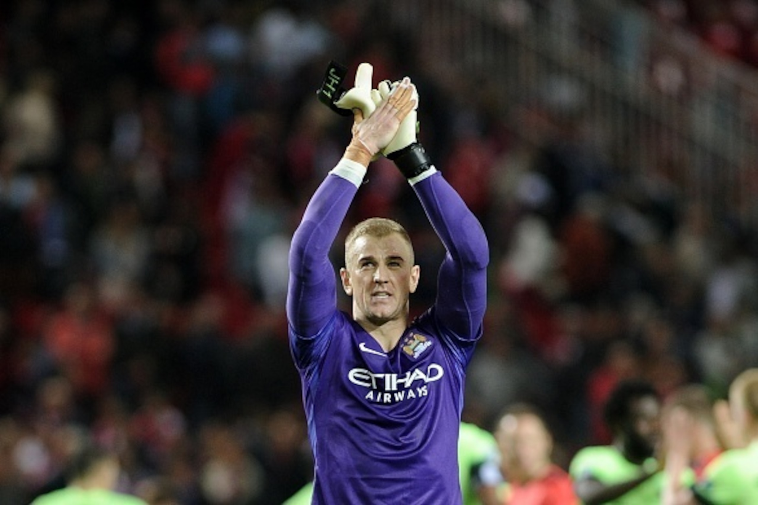 Manchester City's English goalkeeper Joe Hart celebrates after winning during the UEFA Champions League football match Sevilla FC vs Manchester City at the Ramon Sanchez Pizjuan stadium in Sevilla on November 3, 2015.Manchester City won 1-3.  AFP PHOTO / 
