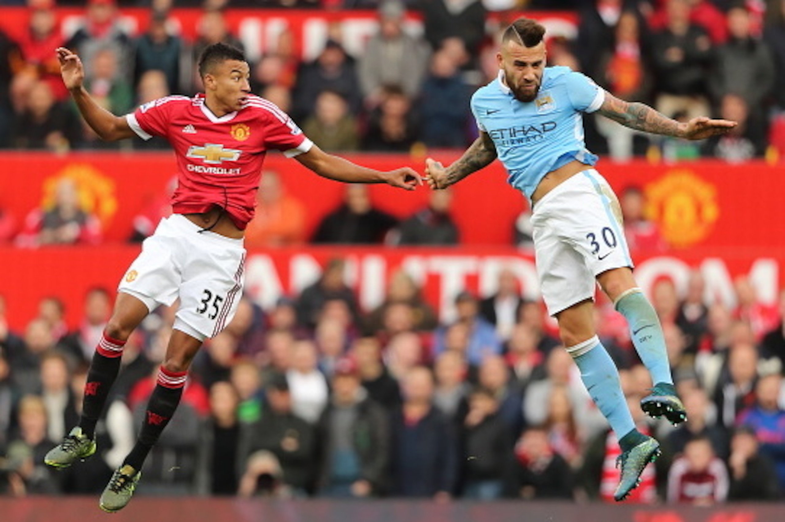 MANCHESTER, ENGLAND - OCTOBER 25:  Jesse Lingard of Manchester United and Nicolas Otamendi of Manchester City during the Barclays Premier League match between Manchester United and Manchester City at Old Trafford on October 25, 2015 in Manchester, England