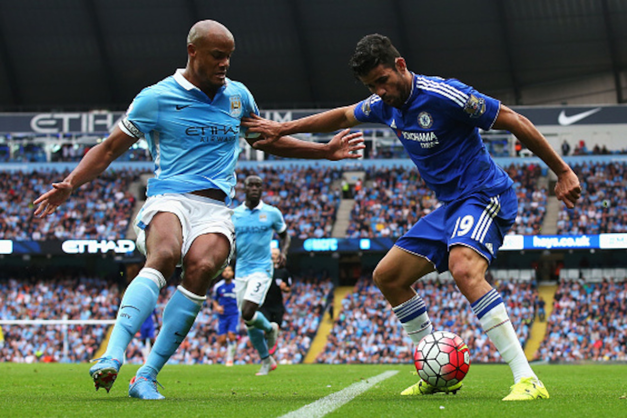 MANCHESTER, ENGLAND - AUGUST 16: Diego Costa of Chelsea holds off Vincent Kompany of Manchester City during the Barclays Premier League match between Manchester City and Chelsea at the Etihad Stadium on August 16, 2015 in Manchester, England.  (Photo by A