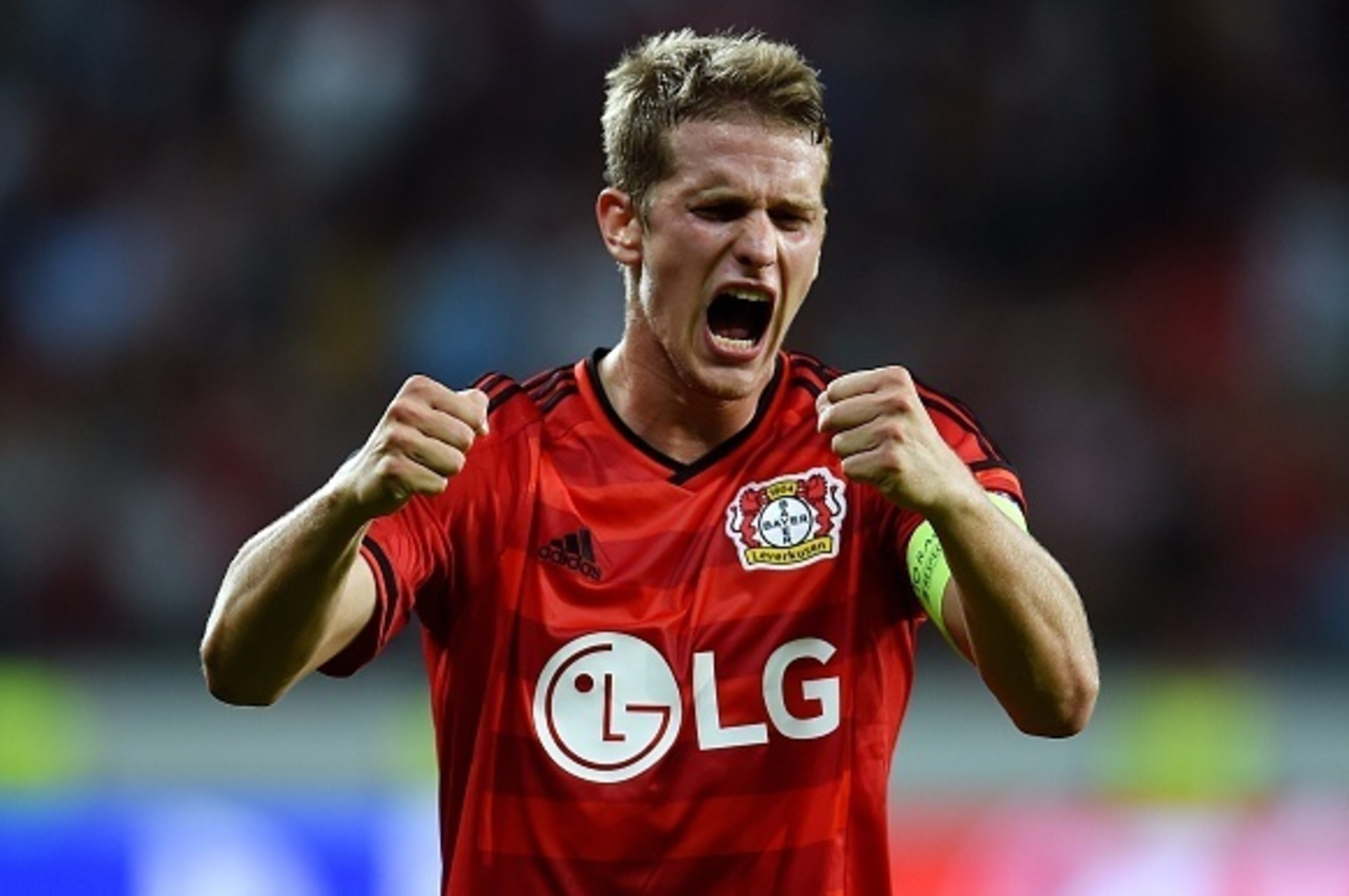 Leverkusen's midfielder Lars Bender celebrates after the UEFA Champions League second leg playoff football match between Bayer Leverkusen and SS Lazio in Leverkusen, western Germany, on August 26, 2015.  Leverkusen wins 3-0. AFP PHOTO / PATRIK STOLLARZ   