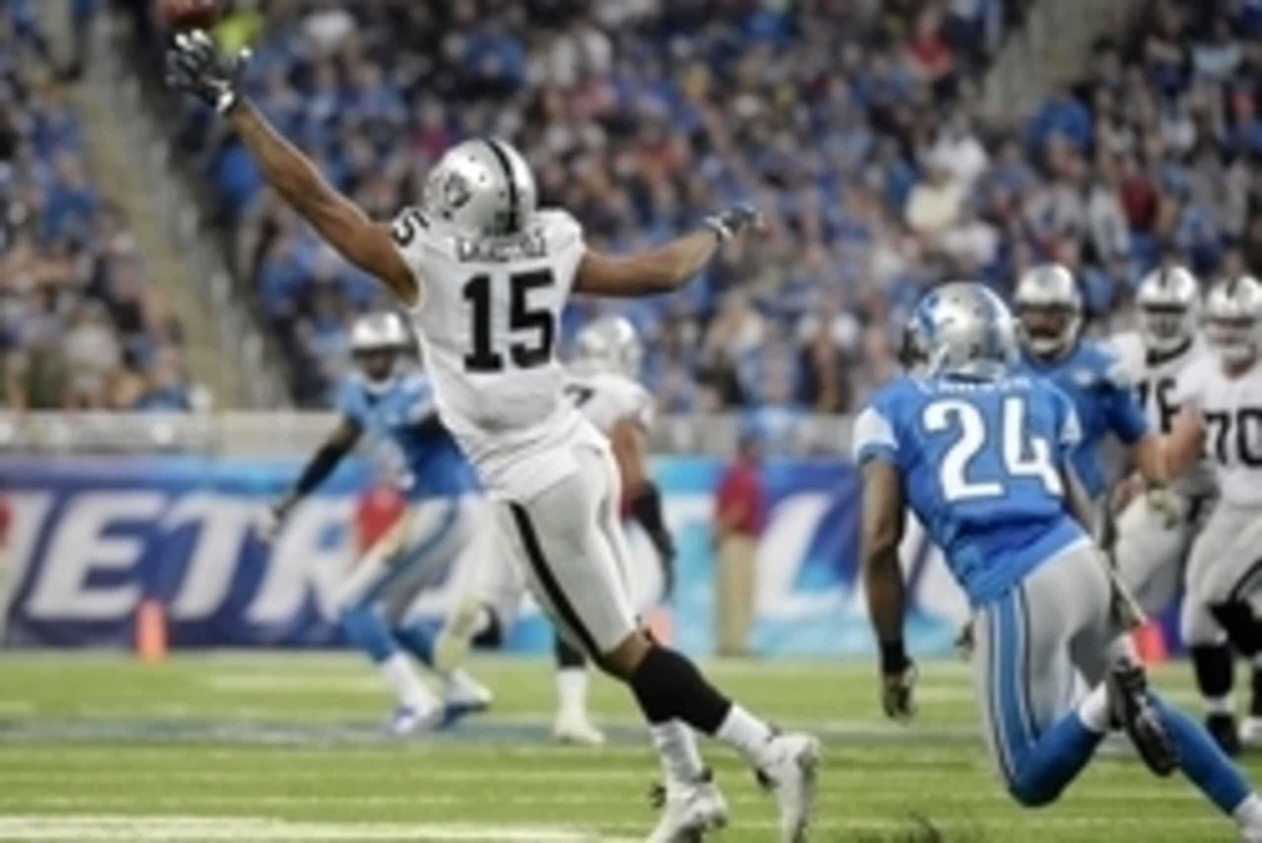 Nov 22, 2015; Detroit, MI, USA; Oakland Raiders wide receiver Michael Crabtree (15) attempts to catch the ball in front of Detroit Lions cornerback Nevin Lawson (24) at Ford Field. The Lions won 18-13. Mandatory Credit: Kirby Lee-USA TODAY Sports