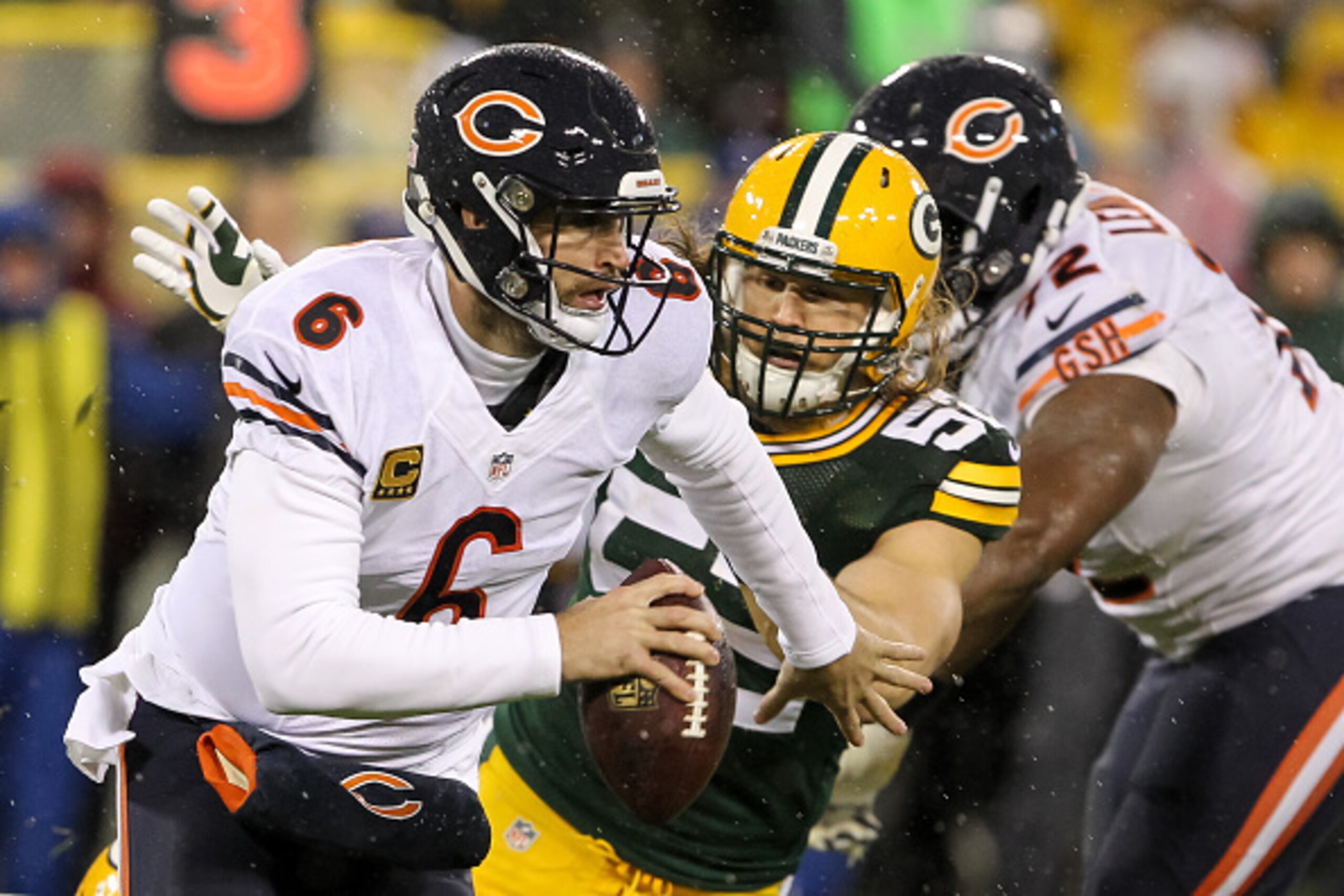 GREEN BAY, WI - NOVEMBER 26:  Quarterback Jay Cutler #6 of the Chicago Bears runs the football against  Clay Matthews #52 of the Green Bay Packers in the first quarter at Lambeau Field on November 26, 2015 in Green Bay, Wisconsin.  (Photo by Kena Krutsing