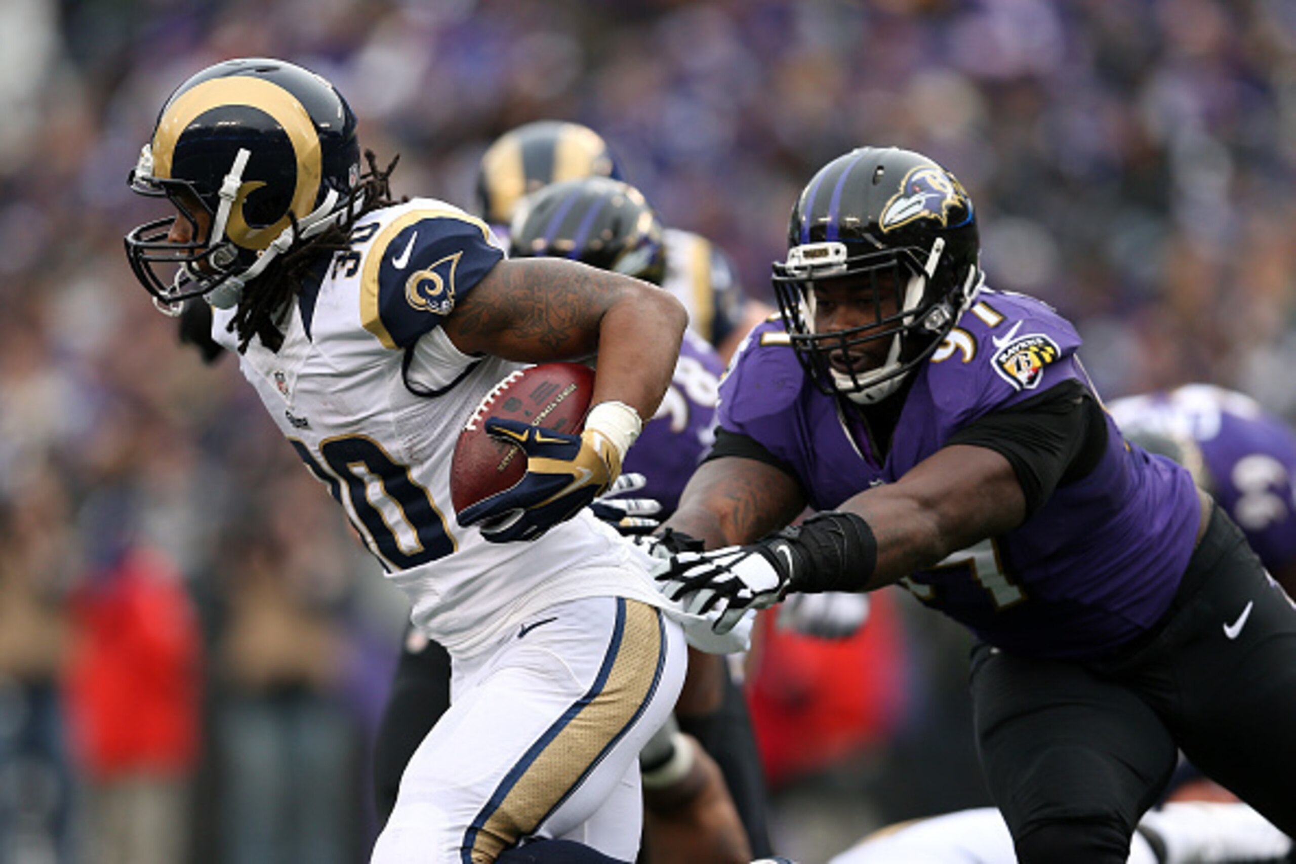 BALTIMORE, MD - NOVEMBER 22: Running back Todd Gurley #30 of the St. Louis Rams rushes past outside linebacker Courtney Upshaw #91 of the Baltimore Ravens in the second quarter at M&T Bank Stadium on November 22, 2015 in Baltimore, Maryland. (Photo by Pat