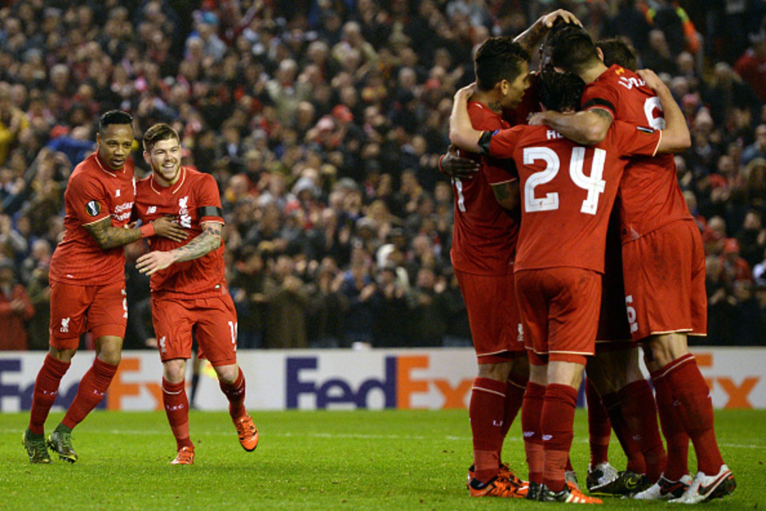 Liverpool's Zaire-born Belgian striker Christian Benteke (R) celebrates with teammates after scoring during a UEFA Europa League group B football match between Liverpool and Bordeaux at Anfield in Liverpool, north west England, on November 26, 2015. AFP P