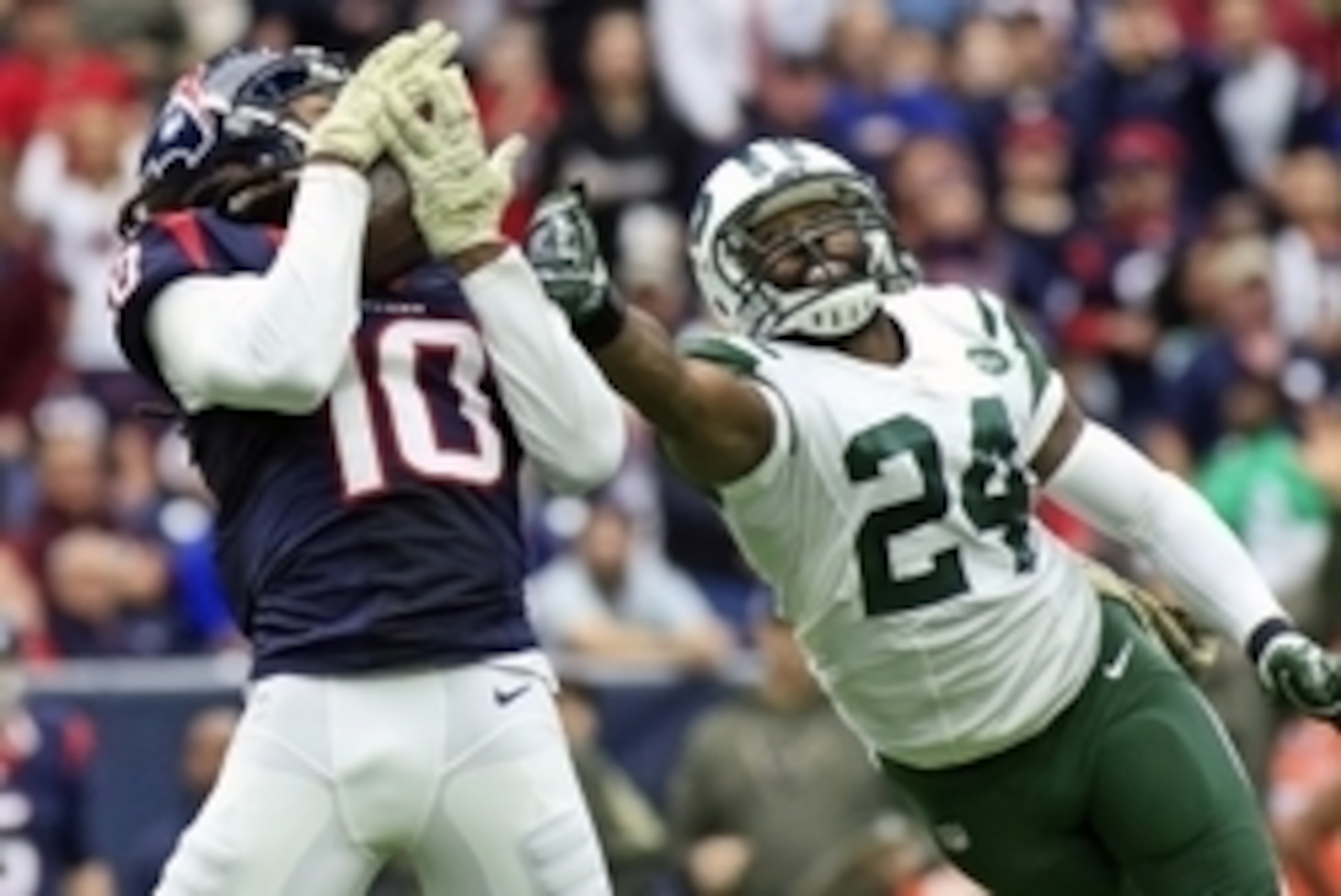Nov 22, 2015; Houston, TX, USA; Houston Texans wide receiver DeAndre Hopkins (10) makes the catch in front of New York Jets cornerback Darrelle Revis (24) for a touchdown during the second quarter of a game at NRG Stadium. Mandatory Credit: Ray Carlin-USA