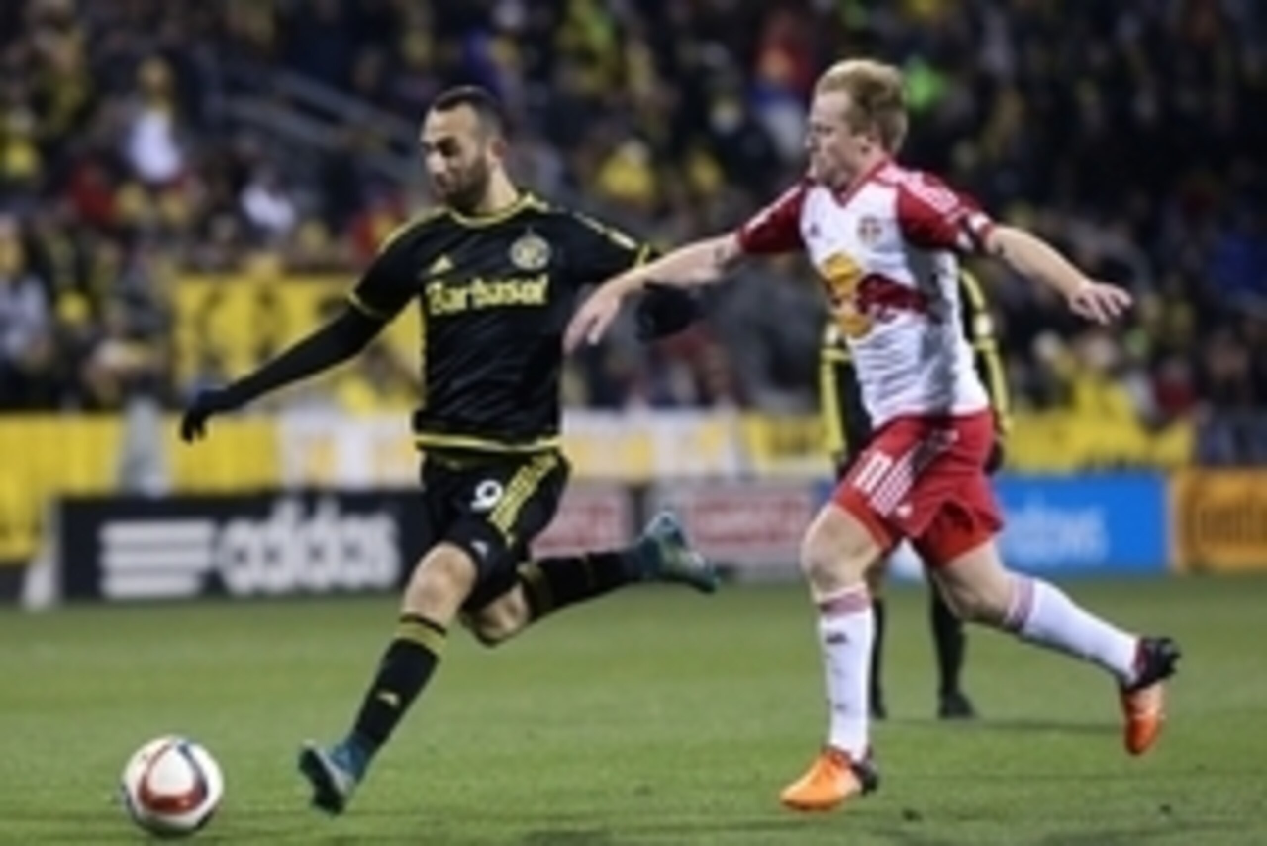 Nov 22, 2015; Columbus, OH, USA; Columbus Crew forward Justin Meram (9) plays the ball past New York Red Bulls midfielder Dax McCarty (11) in the second half of leg one of the Eastern Conference championship at Mapfre Stadium. The Crew won 2-0. Mandatory 