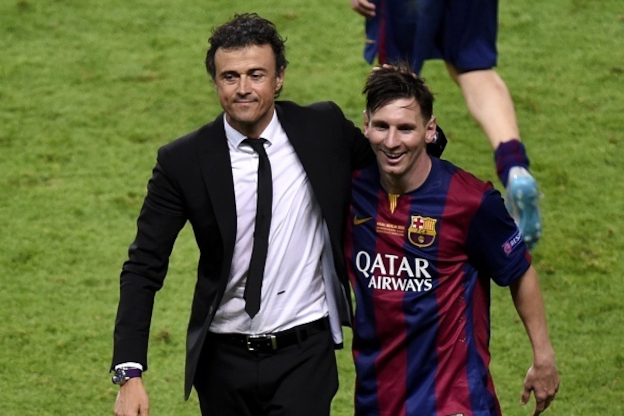 Barcelona's coach Luis Enrique and Barcelona's Argentinian forward Lionel Messi (R) celebrate after winning the UEFA Champions League Final football match between Juventus and FC Barcelona at the Olympic Stadium in Berlin on June 6, 2015.            AFP P