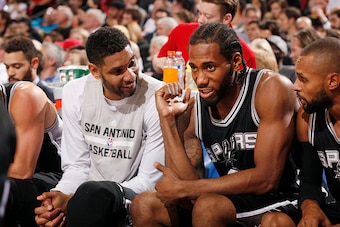 PORTLAND, OR - NOVEMBER 11: Tim Duncan #21 of the San Antonio Spurs and Kawhi Leonard #2 of the San Antonio Spurs during the game on November 11, 2015 at Moda Center in Portland, Oregon. NOTE TO USER: User expressly acknowledges and agrees that, by downlo