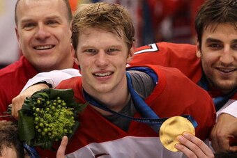 VANCOUVER, BC - FEBRUARY 28:  Eric Staal #21 and Patrice Bergeron #37 of Canada pose for a photo after the ice hockey men's gold medal game between USA and Canada on day 17 of the Vancouver 2010 Winter Olympics at Canada Hockey Place on February 28, 2010 