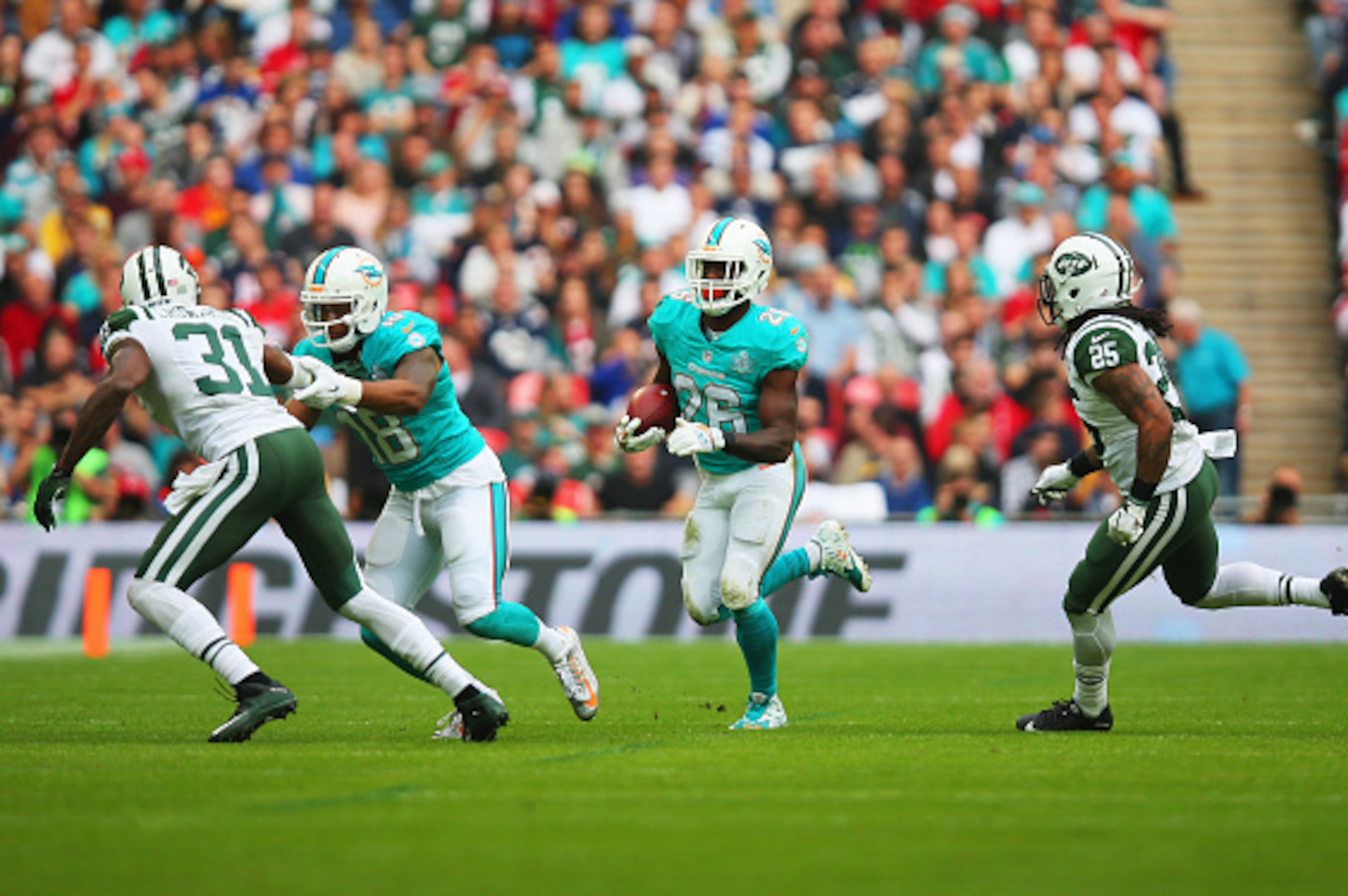 LONDON, ENGLAND - OCTOBER 04: Lamar Miller #26 of the Miami Dolphins is chased by Calvin Pryor #25 of the New York Jets during the game at Wembley Stadium on October 4, 2015 in London, England. (Photo by Bryn Lennon/Getty Images) LONDON, ENGLAND - OCTOBER 04: Lamar Miller #26 of the Miami Dolphins is chased by Calvin Pryor #25 of the New York Jets during the game at Wembley Stadium on October 4, 2015 in London, England. (Photo by Bryn Lennon/Getty Images)