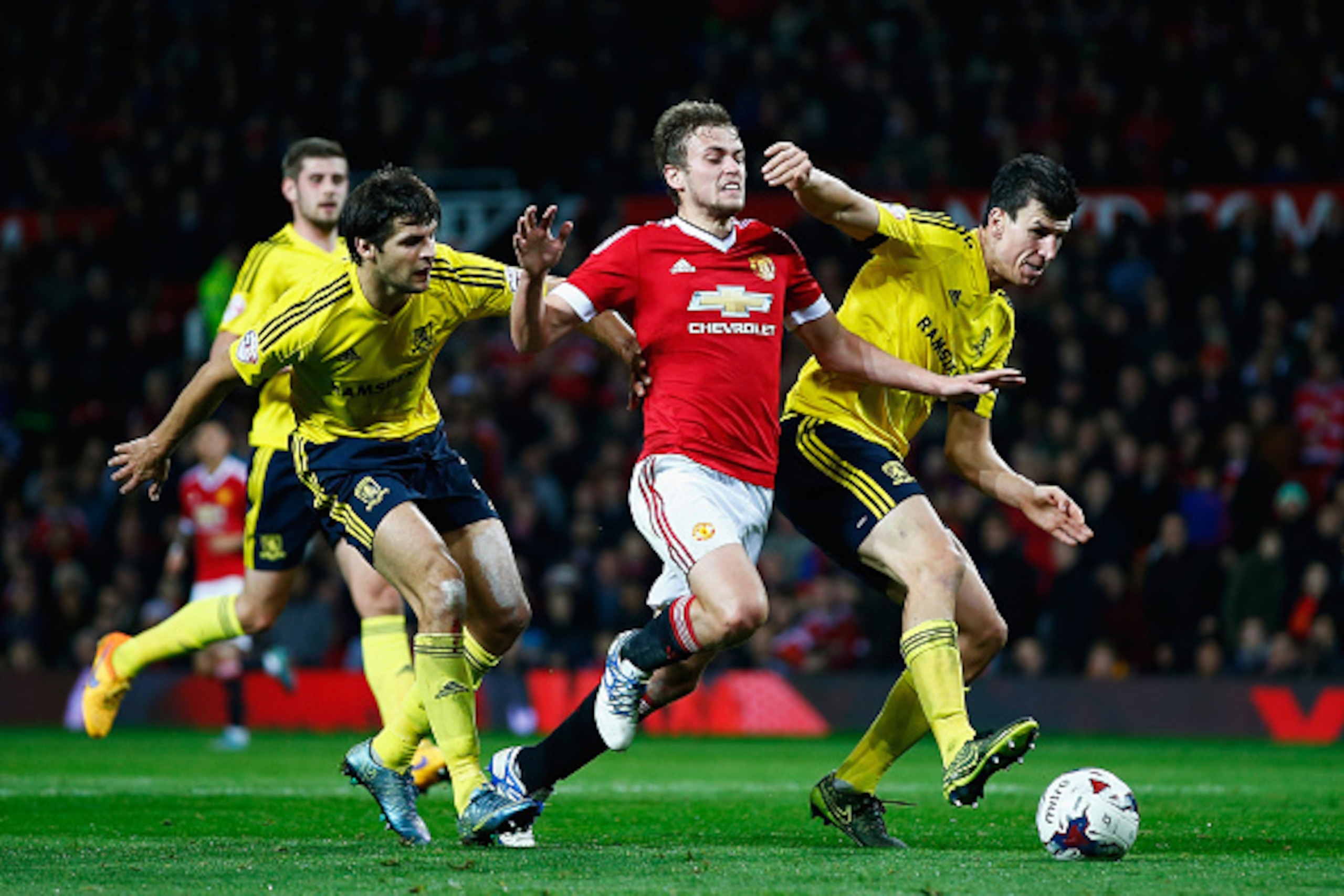 MANCHESTER, ENGLAND - OCTOBER 28:  James Wilson of Manchester United takes on George Friend (L) and Daniel Ayala of Middlesbrough during the Capital One Cup Fourth Round match between Manchester United and Middlesbrough at Old Trafford on October 28, 2015