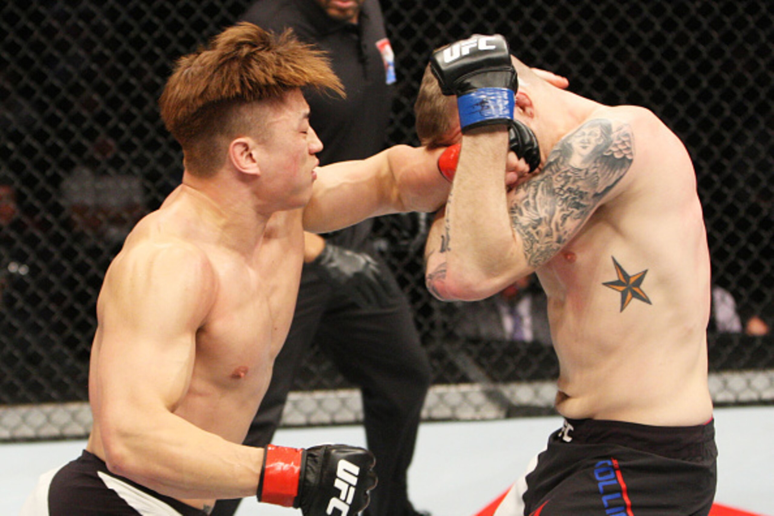 SEOUL, SOUTH KOREA - NOVEMBER 28: Dongi Yang of South Korea punches Jake Collier of the United States of America in their  middleweight bout during the UFC Fight Night at the Olympic Park Gymnastics Arena on November 28, 2015 in Seoul, South Korea. (Photo