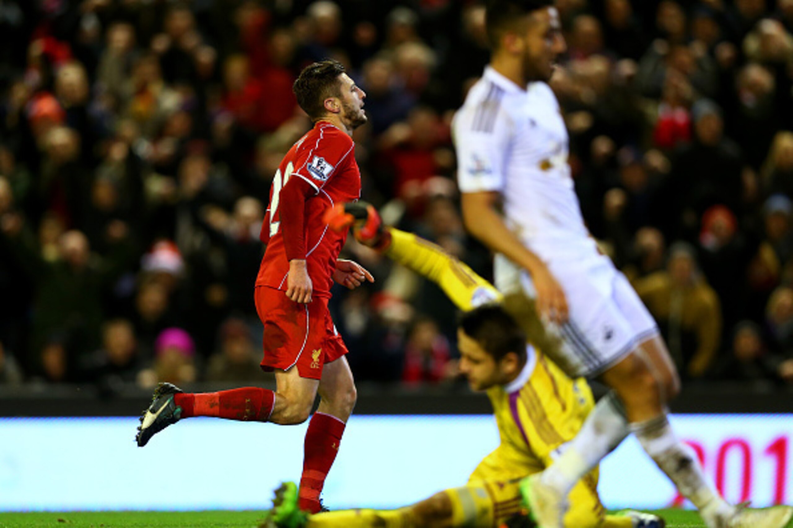 LIVERPOOL, ENGLAND - DECEMBER 29:  Adam Lallana of Liverpool celebrates after scoring his team's third goal during the Barclays Premier League match between Liverpool and Swansea City at Anfield on December 29, 2014 in Liverpool, England.  (Photo by Clive