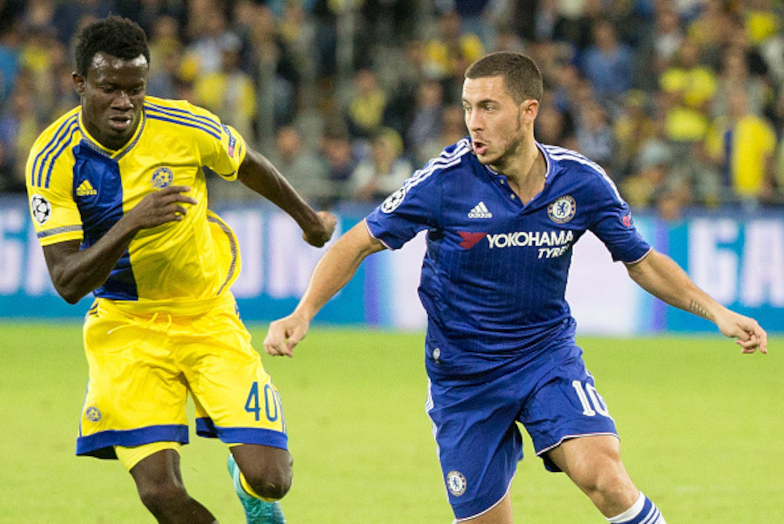 Maccabi Tel Aviv's Nigerian midfielder Nosa Igiebor (L) defends as Chelsea's Belgian midfielder Eden Hazard dribbles the ball during the UEFA Champions League, group G, football match between Maccabi Tel Aviv and Chelsea FC at the Sammy Ofer Stadium, in t