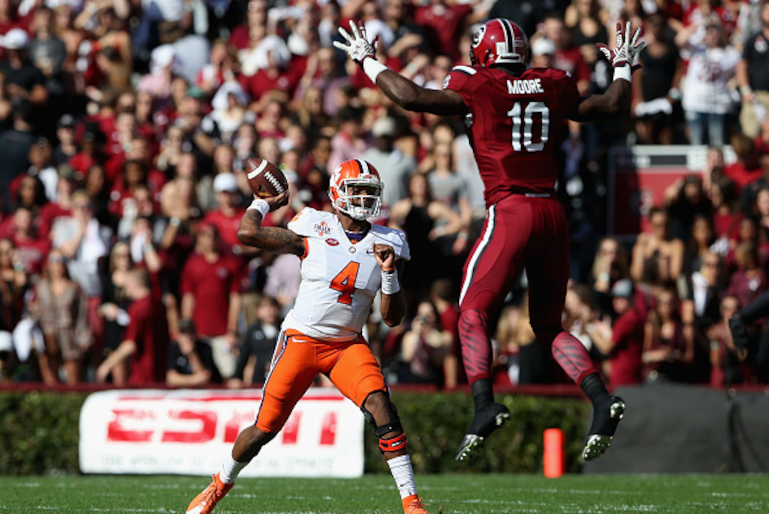 COLUMBIA, SC - NOVEMBER 28:  Skai Moore #10 of the South Carolina Gamecocks tries to stop Deshaun Watson #4 of the Clemson Tigers from throwing a pass during their game at Williams-Brice Stadium on November 28, 2015 in Columbia, South Carolina.  (Photo by
